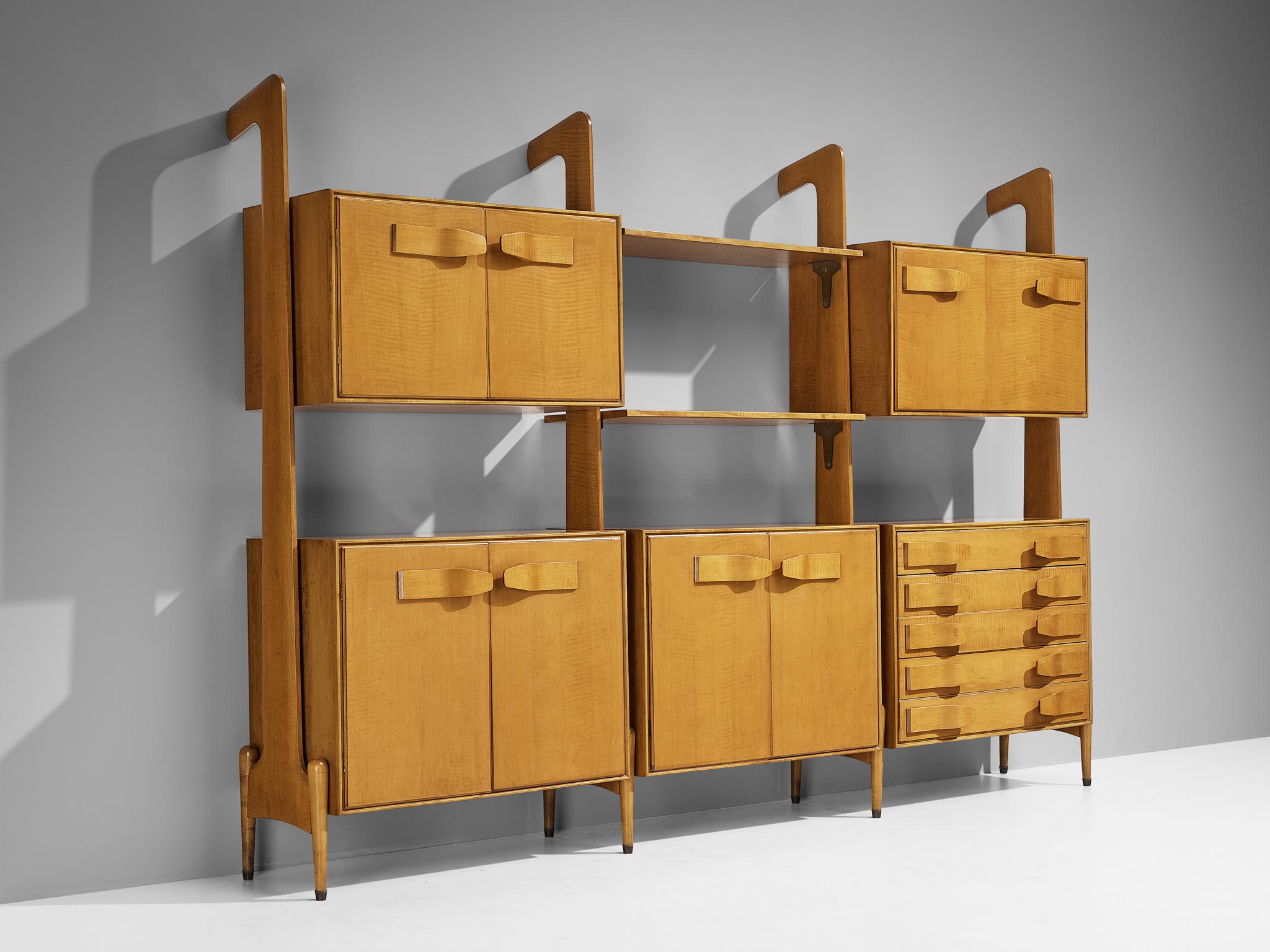 Wall unit, cherry, brass, Italy, 1960s

Hailing from a skilled artisan of Italy, this exceptional library unit excels in form, Material use, composition, and craftsmanship. The bookcase reflects the design principles of the midcentury era that