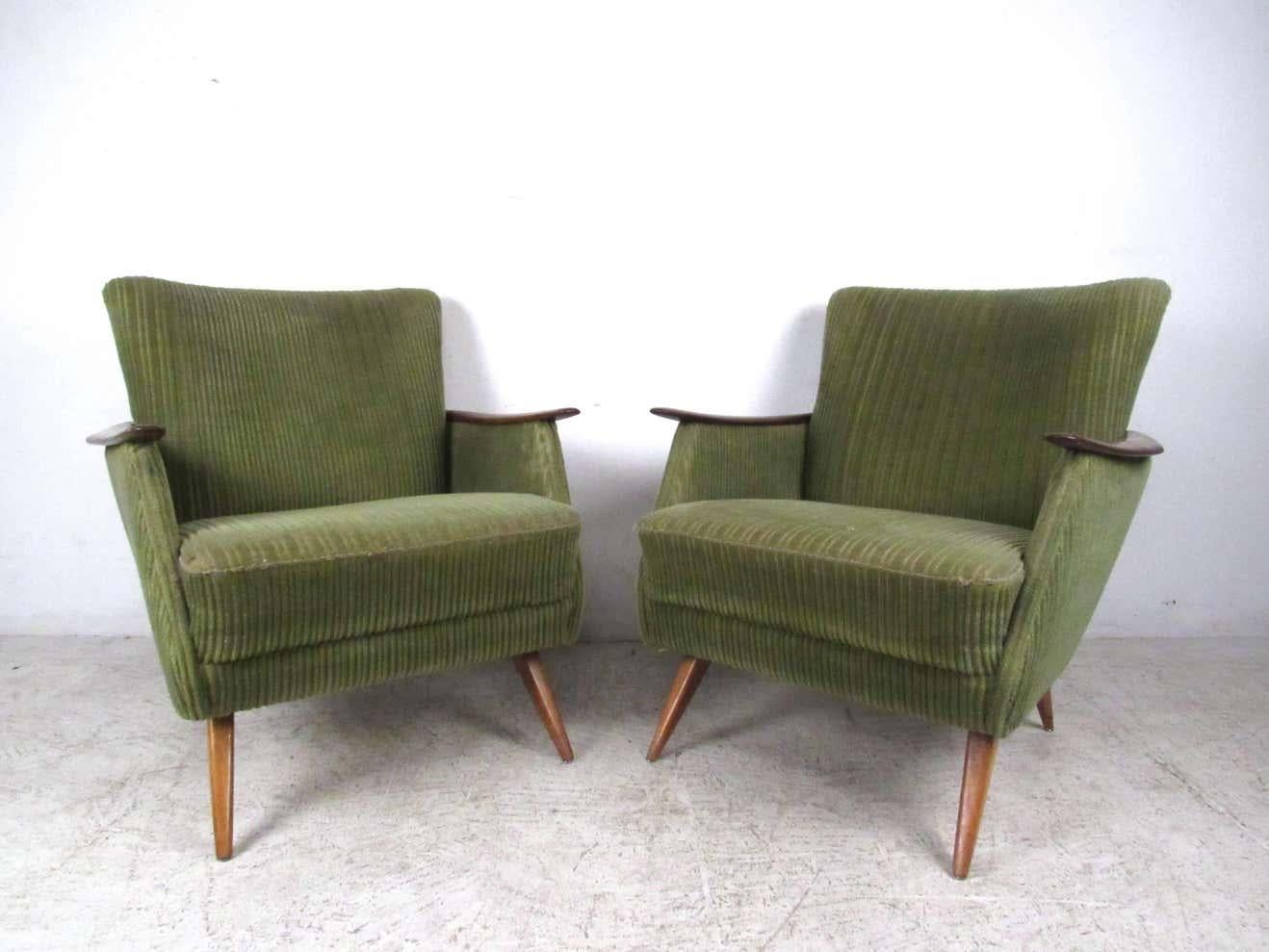 This stunning pair of vintage Danish armchairs features unique tapered legs, sculpted wooden arms, and wraparound wood trim. The vintage style and modern comfort of the pair make these a unique addition to any interior.