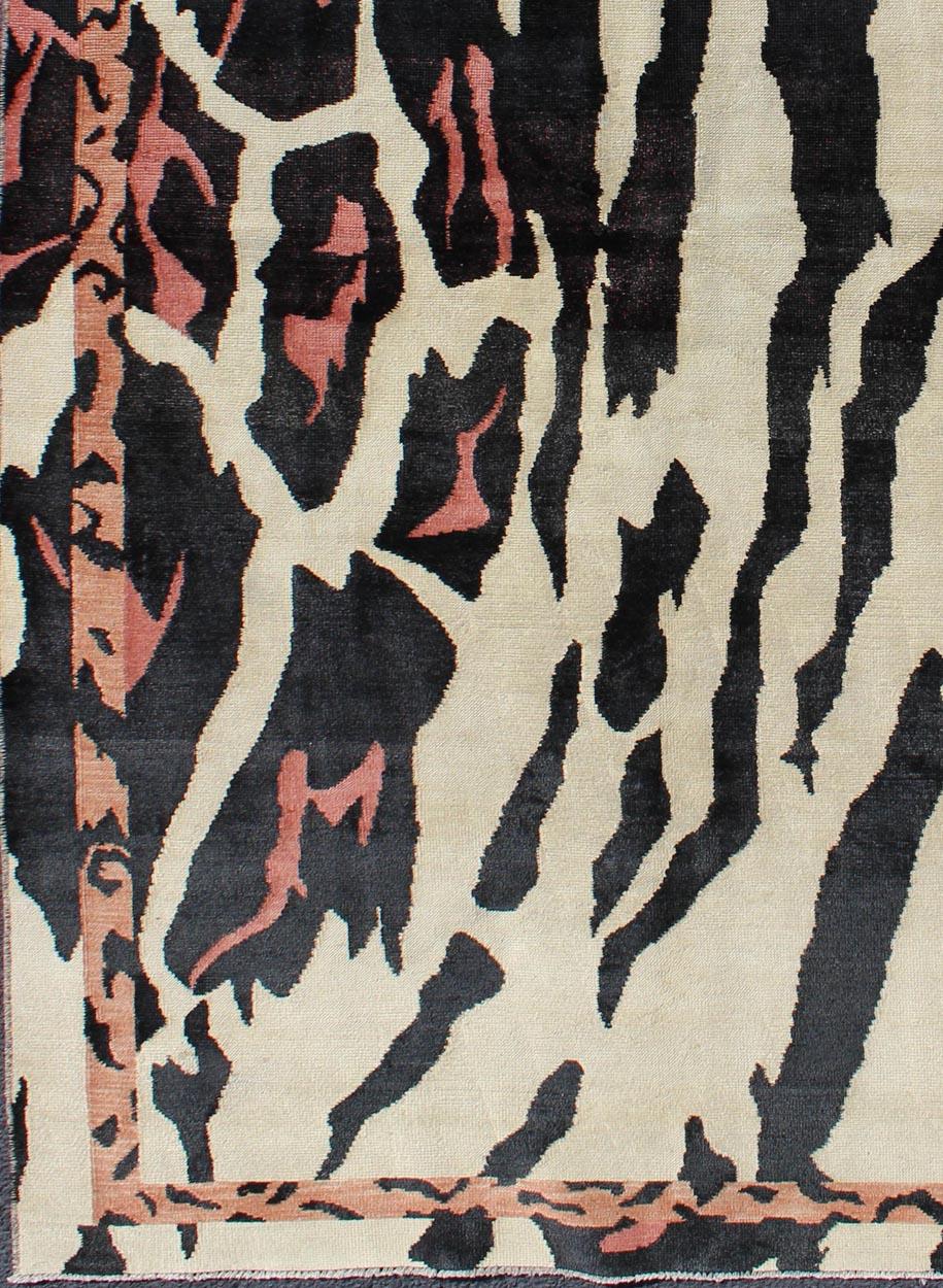 Measures: 4'7 x 7'6.
This handwoven carpet is finely woven and displays a unique design and color combination reminiscent of zebra print, with a spotted and speckled assortment light water melon, pink and light rust/peach colors creating a