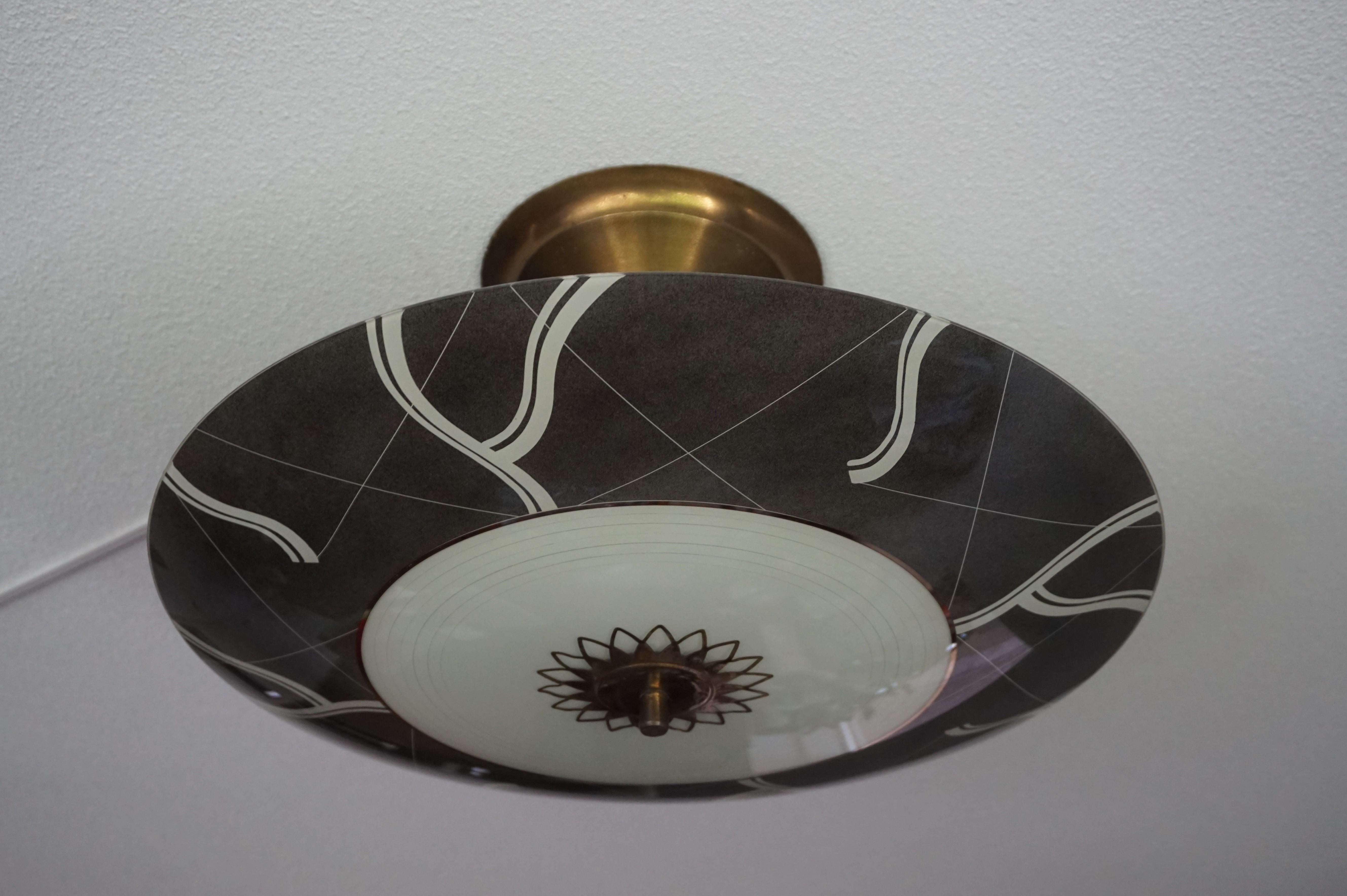 Rare and great looking, three light midcentury flush mount.

This midcentury light fixture with the unique 'eye ball' pattern is another one of our recent great finds. Both with the light switched on and off this Fine work of lighting art from the
