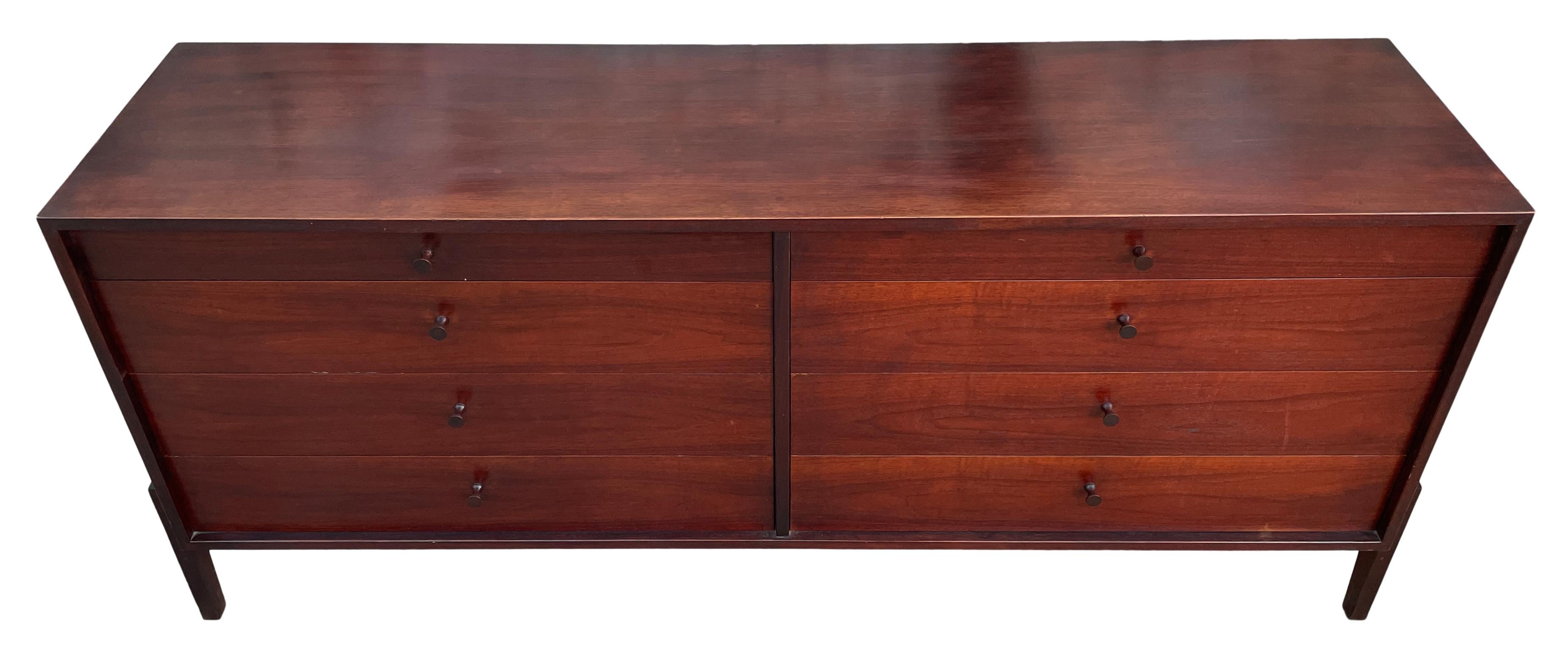 Unique Mid-Century Modern long walnut 8-drawer dresser credenza with all solid walnut knobs. Great design good vintage condition with stunning Patina. Has unique optional wood base. Rare dresser by Calvin Furniture Company designed by Kipp Stewart &