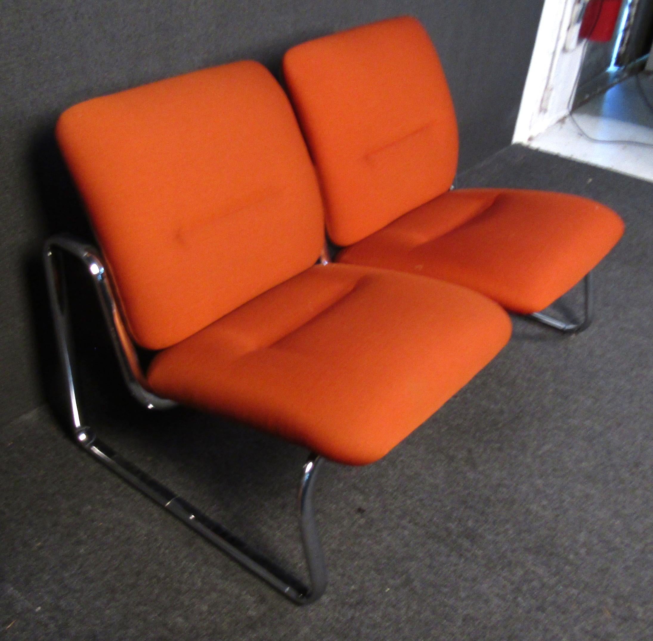 Beautiful vintage modern two seat bench/ loveseat. Upholstered in a beautiful vibrant orange fabric in amazing condition. The bench sits on sculptural bent chrome legs and has a molded plastic backing.

Please confirm item location (NY or NJ).