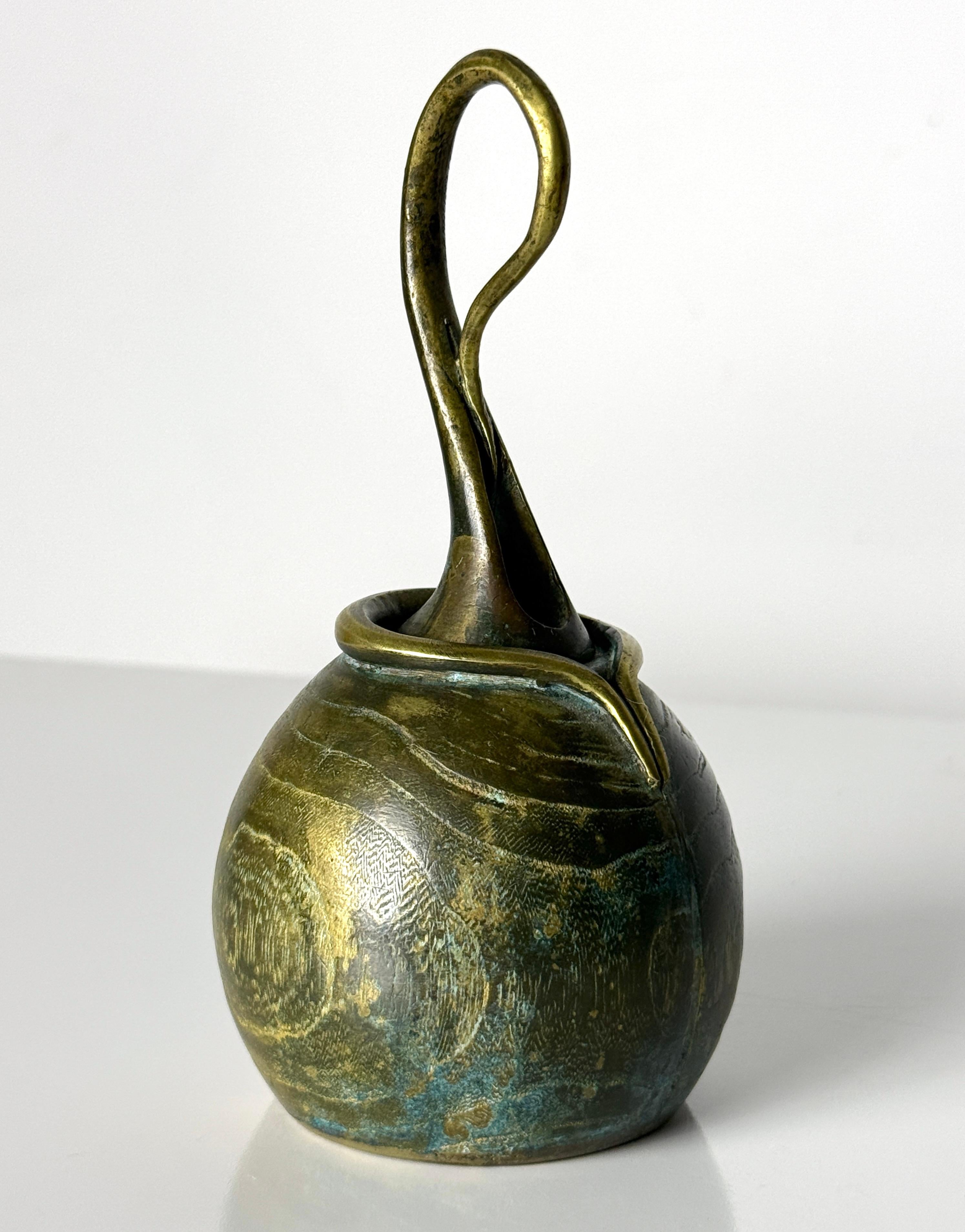Sculptural artist made cast bronze bell signed Francisco 1977

Organic design with wood grain like texture and verdigris patina
Fluid looped handle is seamlessly integrated and signed to interior

3.25 inch diameter
6.5 inch height