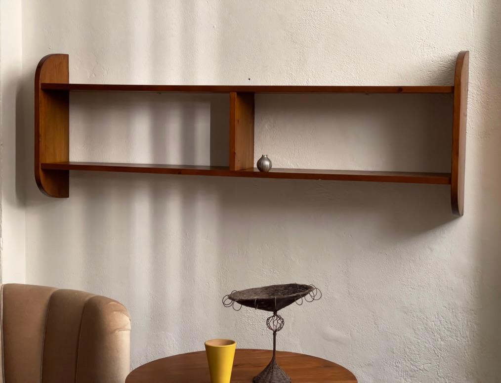 Unique midcentury Scandinavian shelf in rich dark patinated solid pine wood. Carefully crafted by cabinetmaker with elegant visual proportions featuring two horizontal boards and two half curved vertical ends stabilized by one vertical middle part.