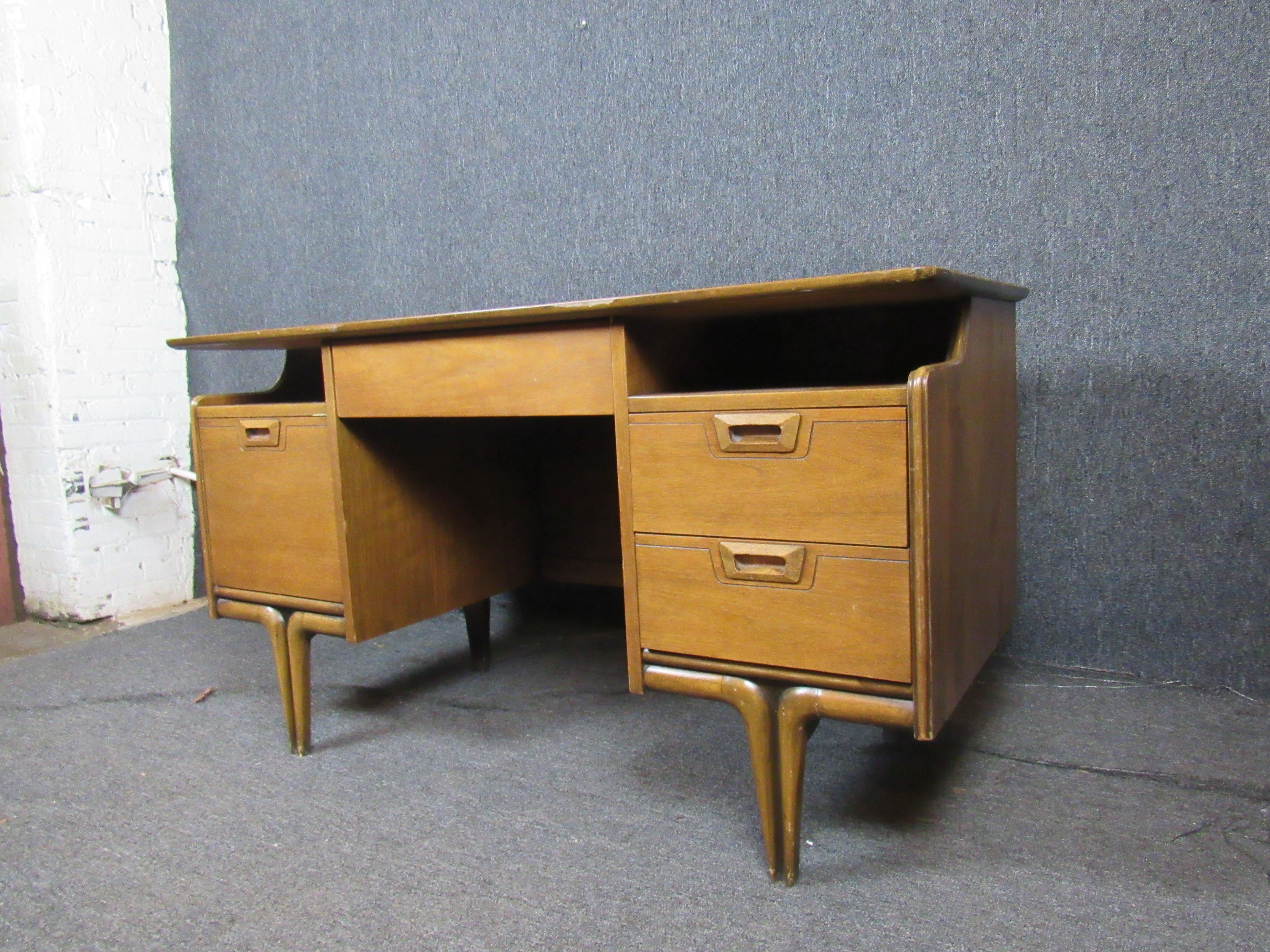 Absolutely stunning vintage desk with unique accents that set it apart from the crowd! A semi-floating top combines with beautiful sculpted legs and a finished back are sure to make this desk a statement piece, no matter what room it's in. Four