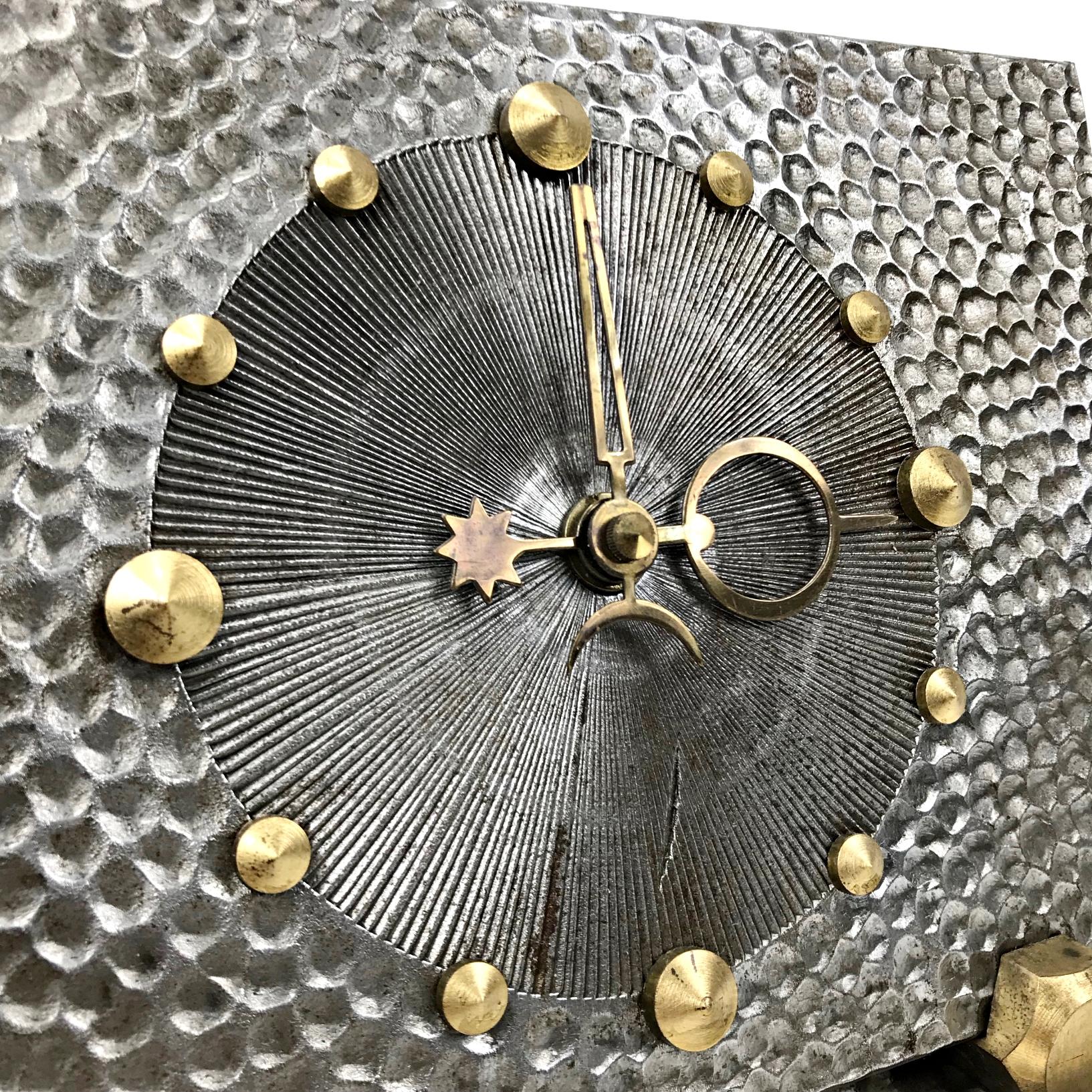 Impressive unique table clock made in West Germany. Heavy hammered steel body with brass details. Great condition with original Junghans quartz AAA battery mechanism.

Measures: 
Height 17 cm / 6.7 in. 
Diameter 22 cm / 8.6 in.
D 9 cm / 3.5 in.