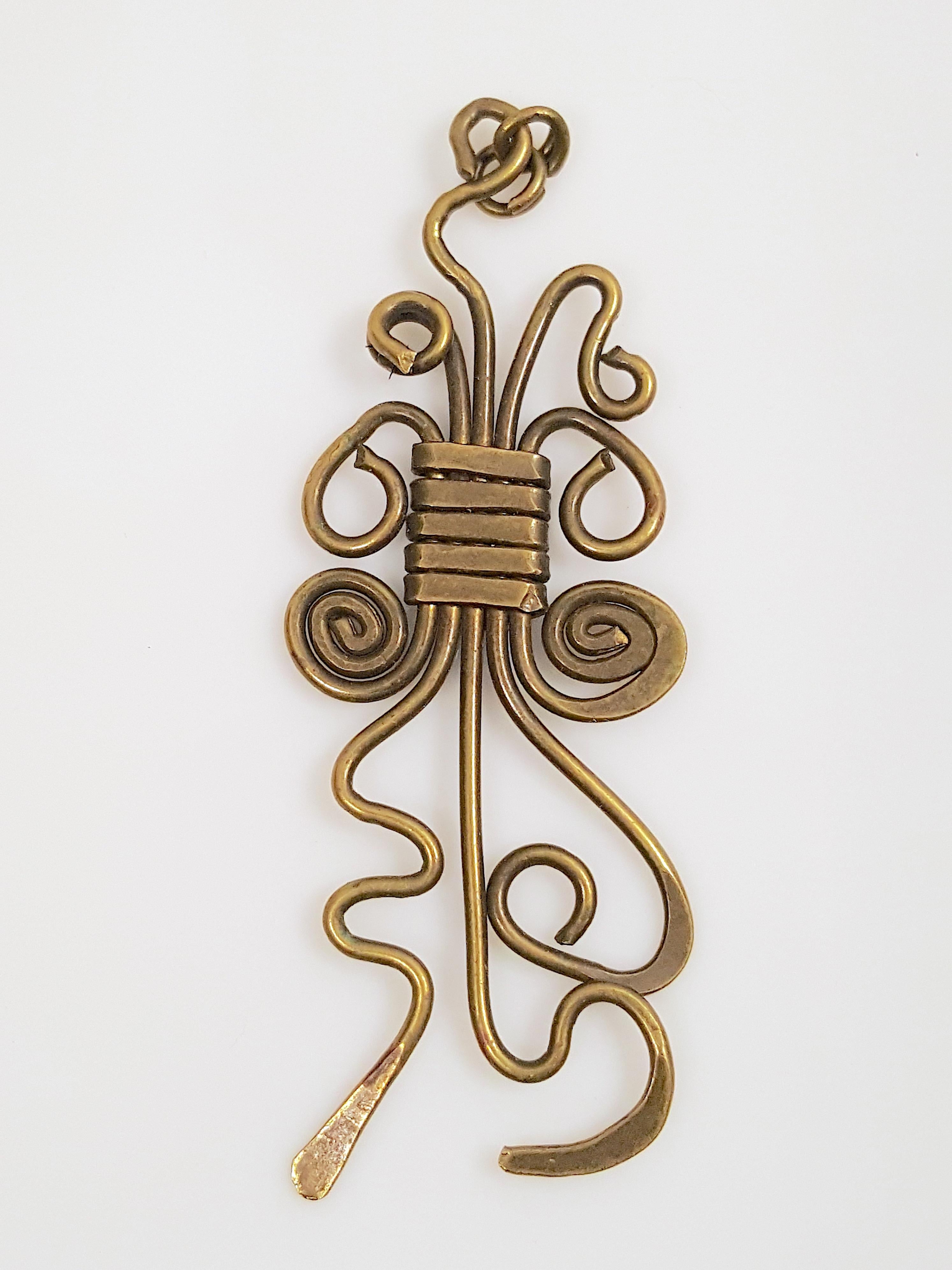 This vintage handcrafted brass-wire pendant was shaped and hammered into lively three-dimensional spirals, loops and squiggles with wrapped construction by an unknown 20th-Century studio artist judging from the lack of copyright/signature, modern