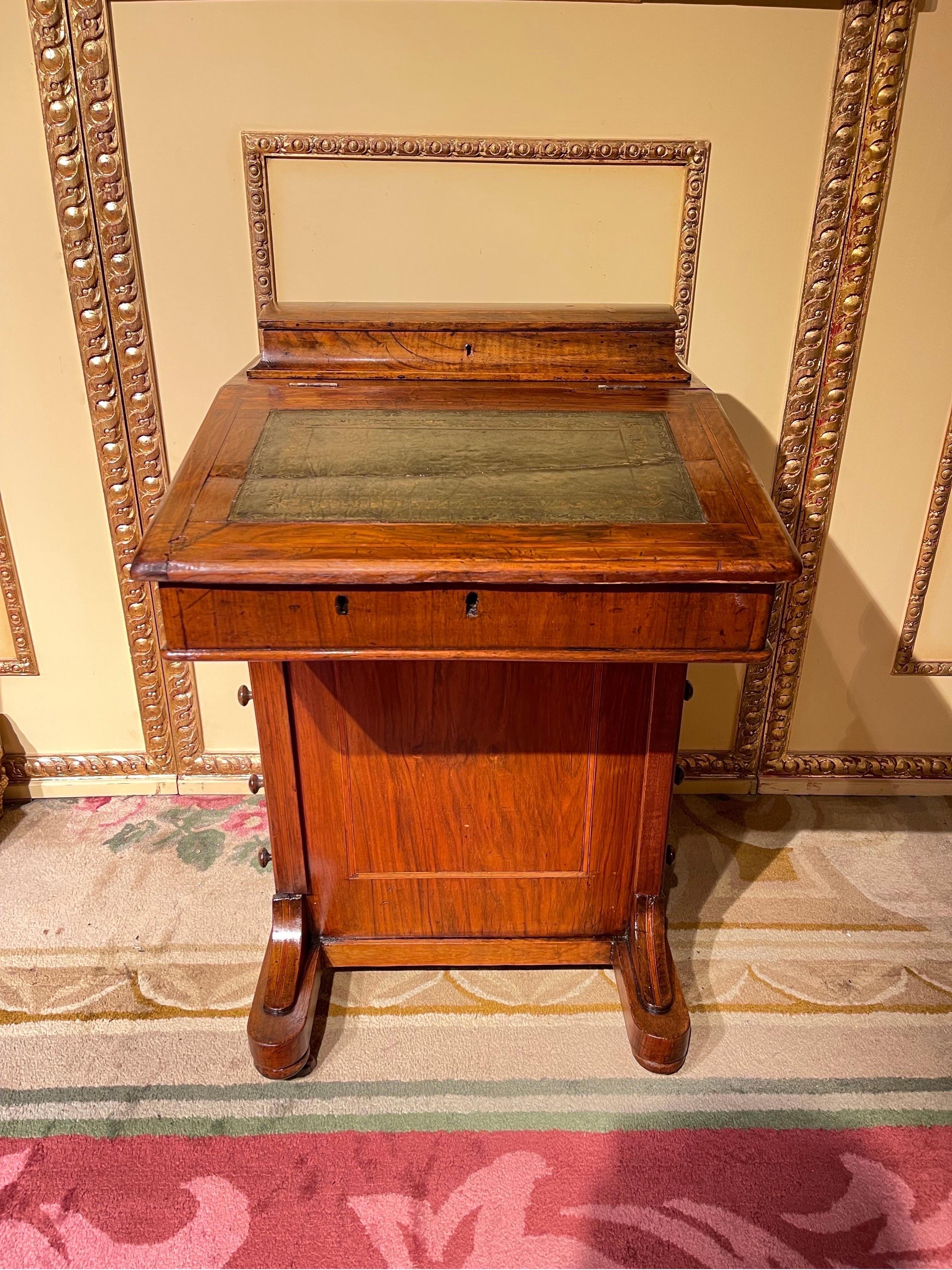 Unique mini desk/lady's desk, England 1890

Curious ladies desk, England. Folding writing surface made of solid wood.
With various drawers and compartments for sufficient storage space.