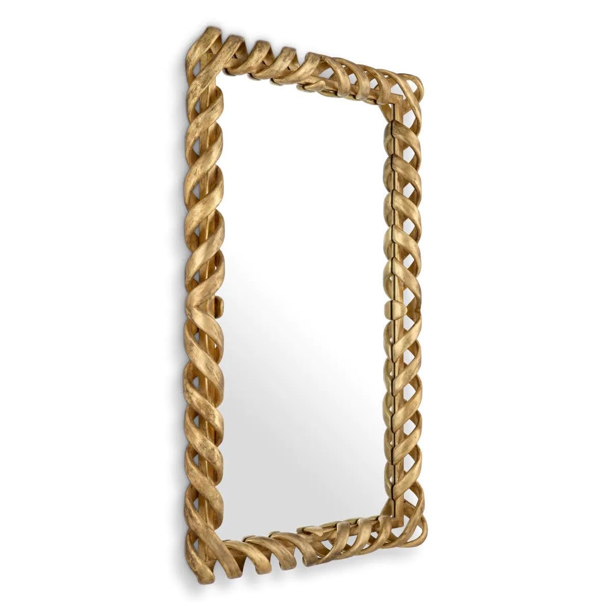 Immerse yourself in the timeless elegance of this wall mirror.
This luxurious piece, handcrafted from wood and adorned with an antique gold finish, exudes opulence thanks to its unique twisted rope frame and intricate carved details, making it a
