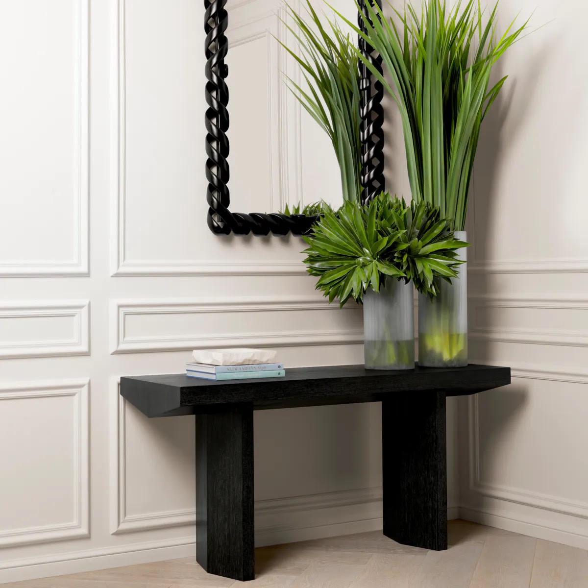 Elegati nell'eleganza senza tempo di questo specchio.
Questo lussuoso pezzo, realizzato a mano in legno e impreziosito da una finitura nero pianoforte, emana opulenza grazie all'esclusiva struttura in corda intrecciata e agli intricati dettagli