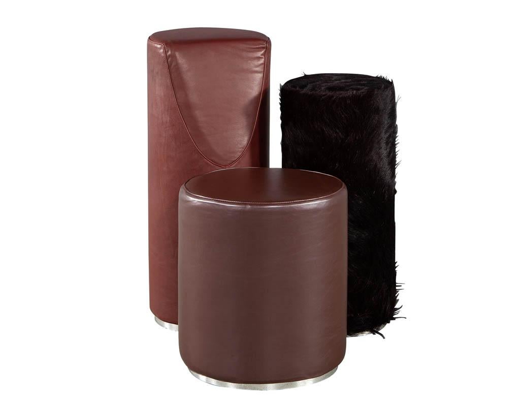 Unique modern pillar accent chair by Bruno Rainaldi. Amazing modern eccentric design is sure to evoke interest and conversation to those around it. The 3-pillar design consists of vinyl material in dark plum and burgundy with accenting pillar in