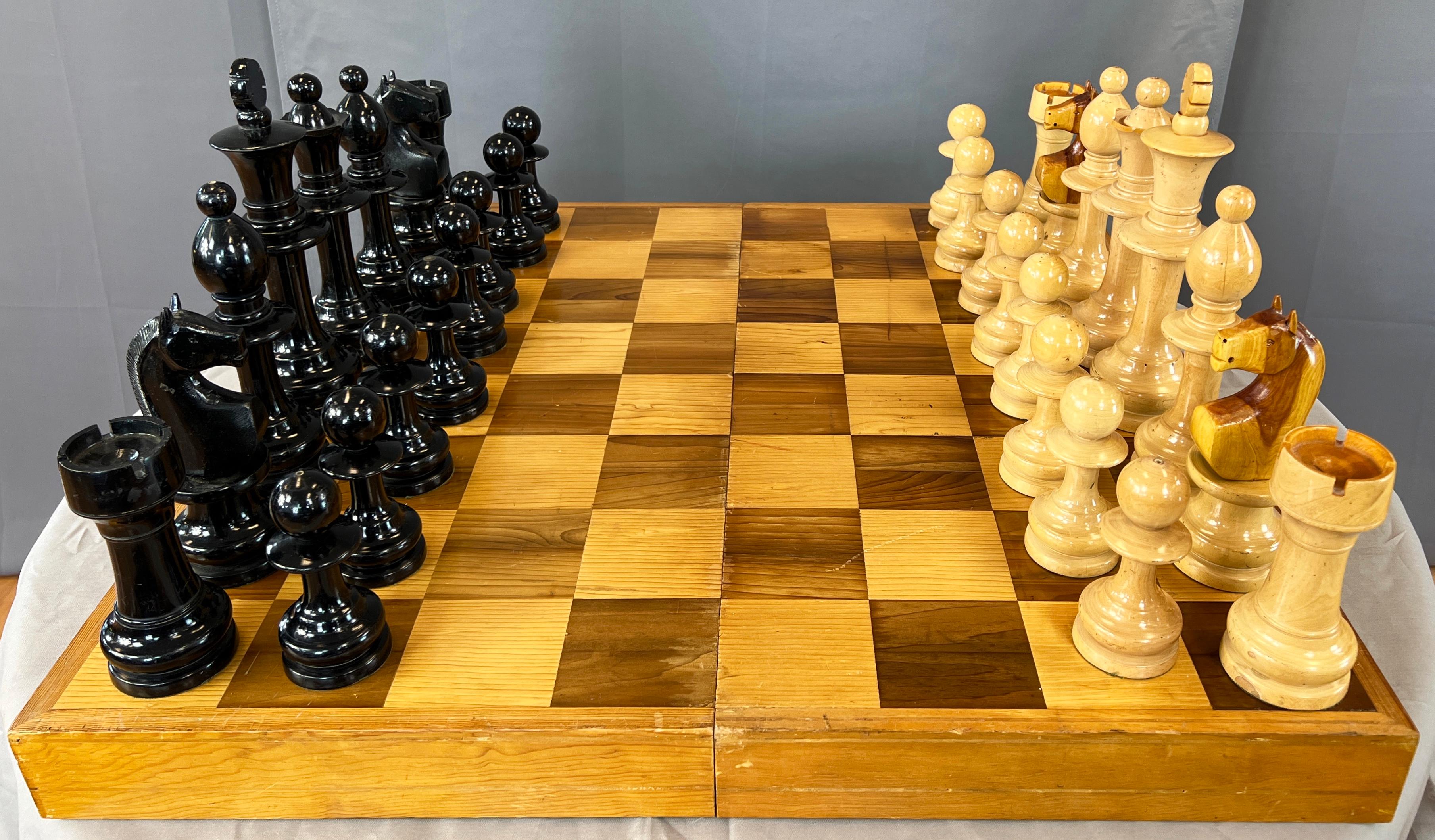 Offered here is monumental hand crafted chess set, it's 33 pieces total including the game board/case.

Artist/craftsman is unknown, set is not signed. Board is also the storage case for the set.

King measurements below are for the King, Queen is