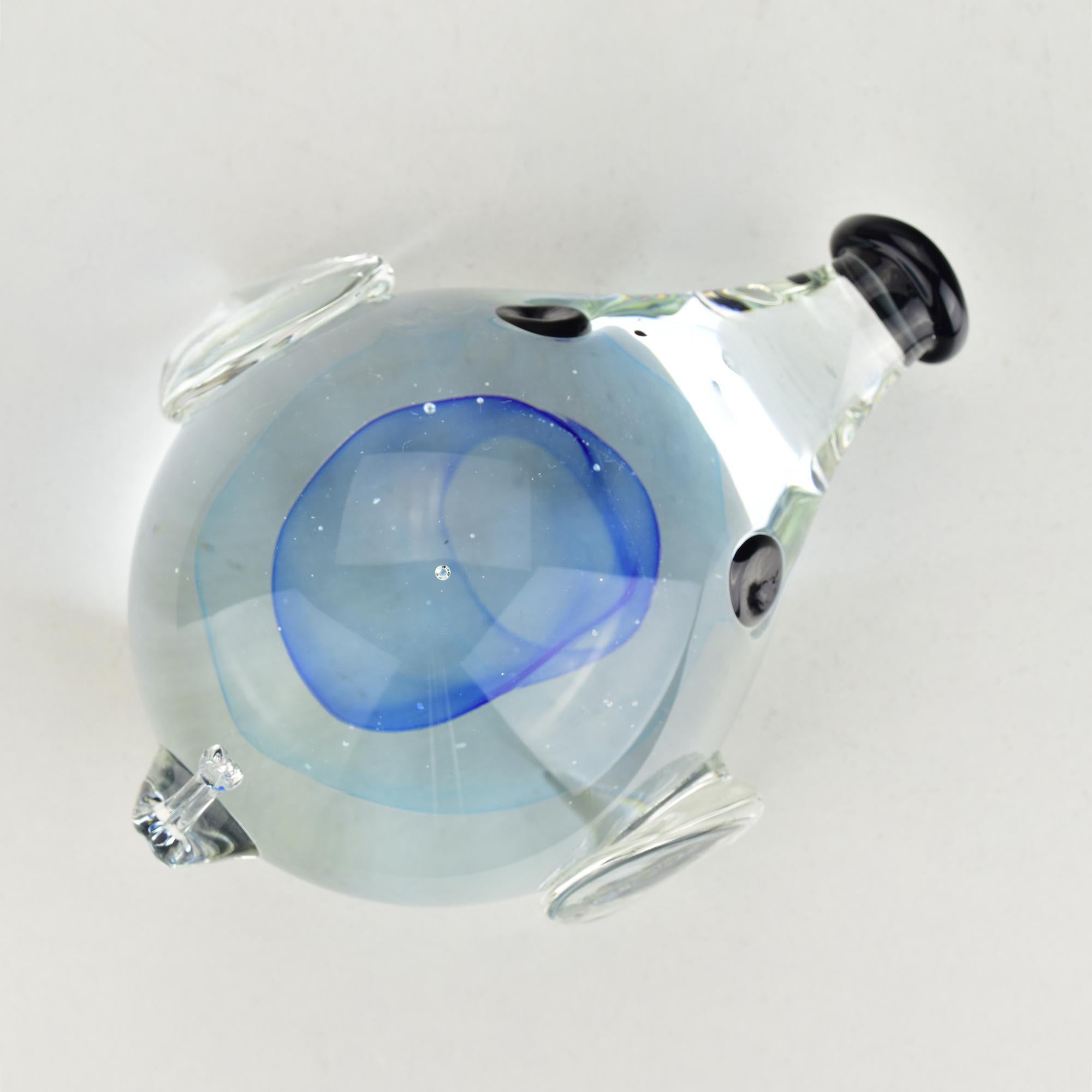 This exquisite Murano glass dachshund figurine was designed by Antonio da Ros for Cenedese in the 1960s. The sculpture features a vibrant blue core encased in clear glass, accented by black details on the eyes and nose. 

Its playful form captures