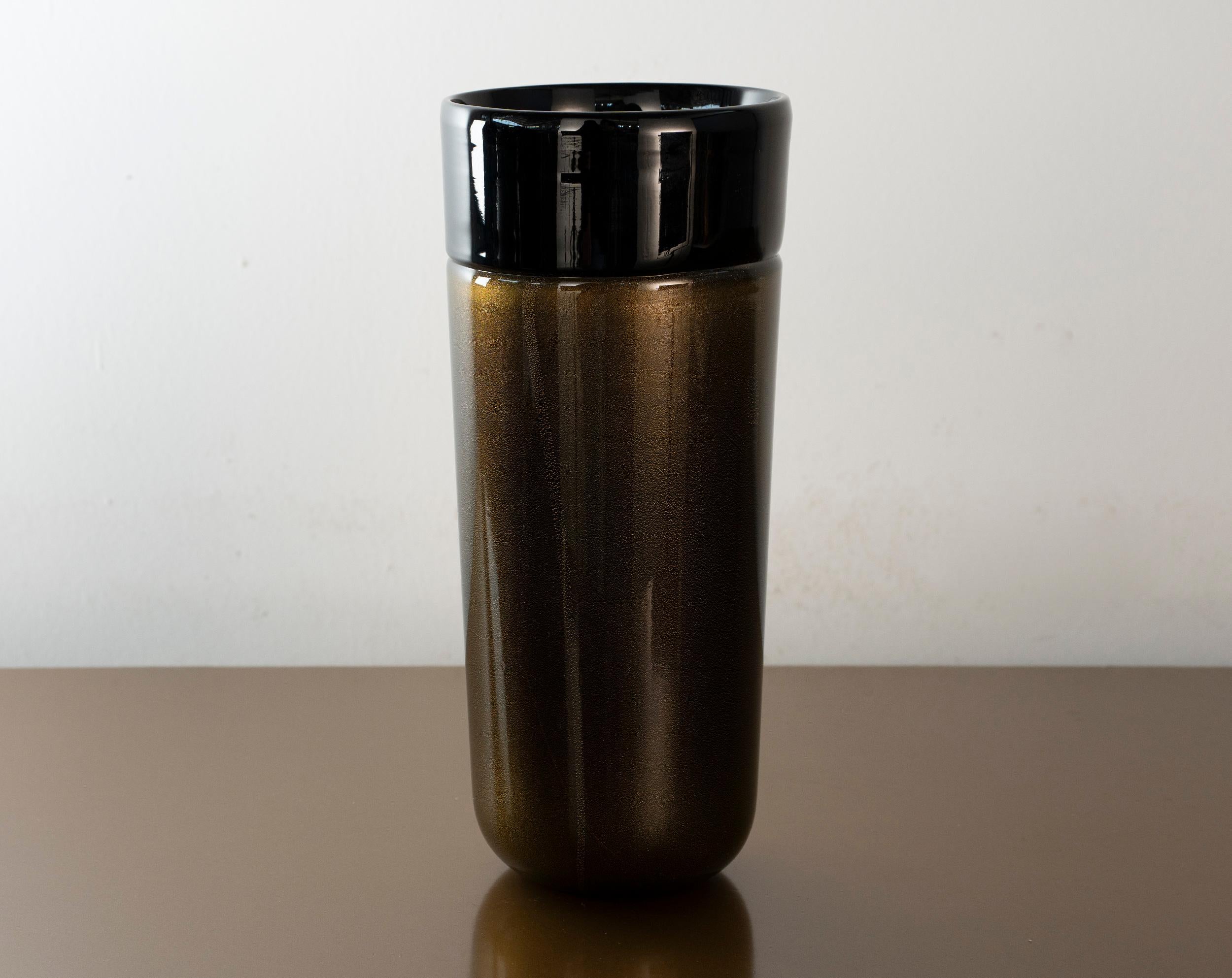 An extraordinary Murano vase of bold black glass enriched with delicate gold leaf inclusions. The piece still bears the original Vetri Murano (VM) consortium label, with the code “044” that was assigned to the OBALL glass factory in the 1980s.

This