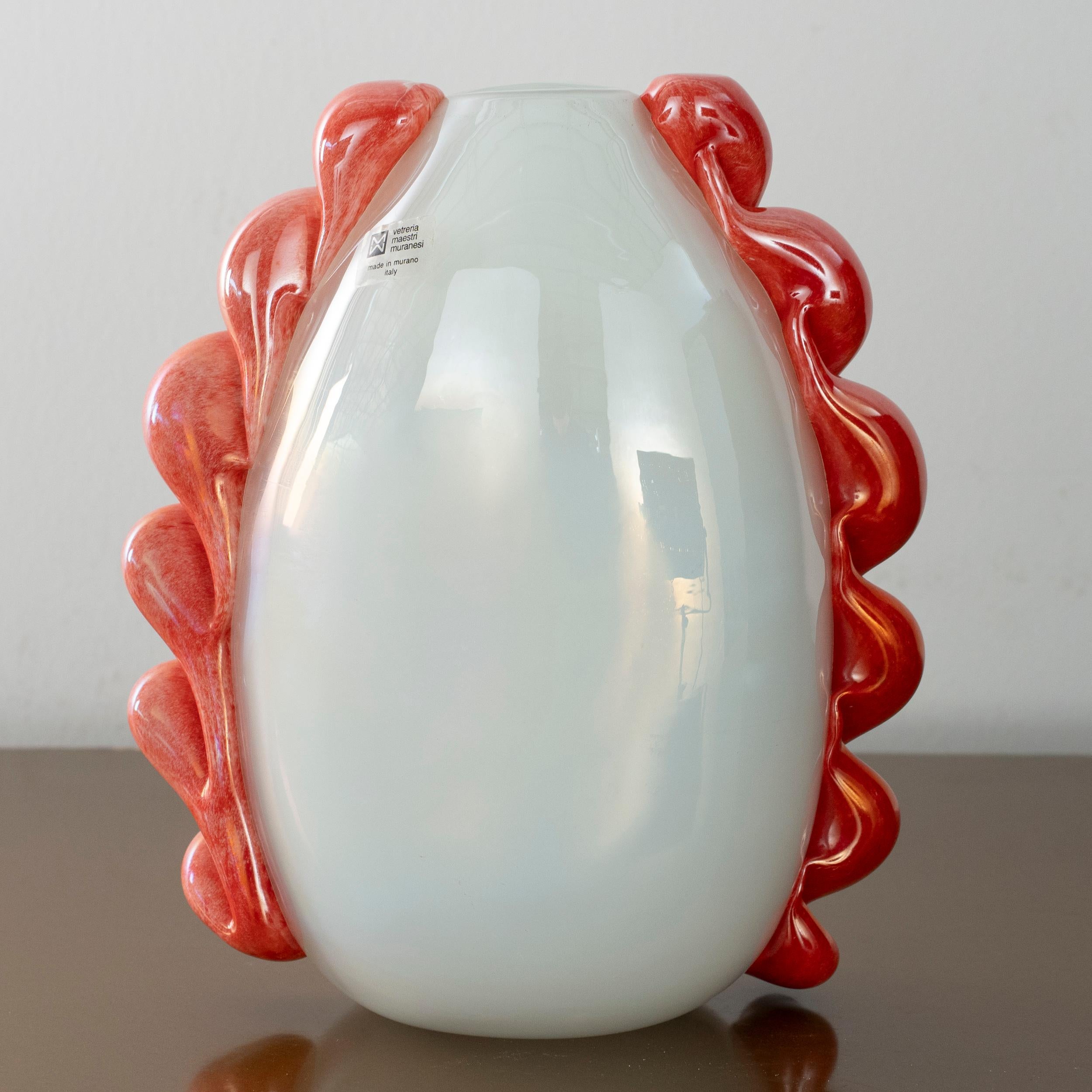 Hand-blown decorative vase, produced in Murano, Italy, by Vetreria Maestri Muranesi, circa 1980s.

This piece is made of white opaline glass, shaped into a balanced ovoid form, with a narrow flat base and a slightly tapering neck. On both sides of