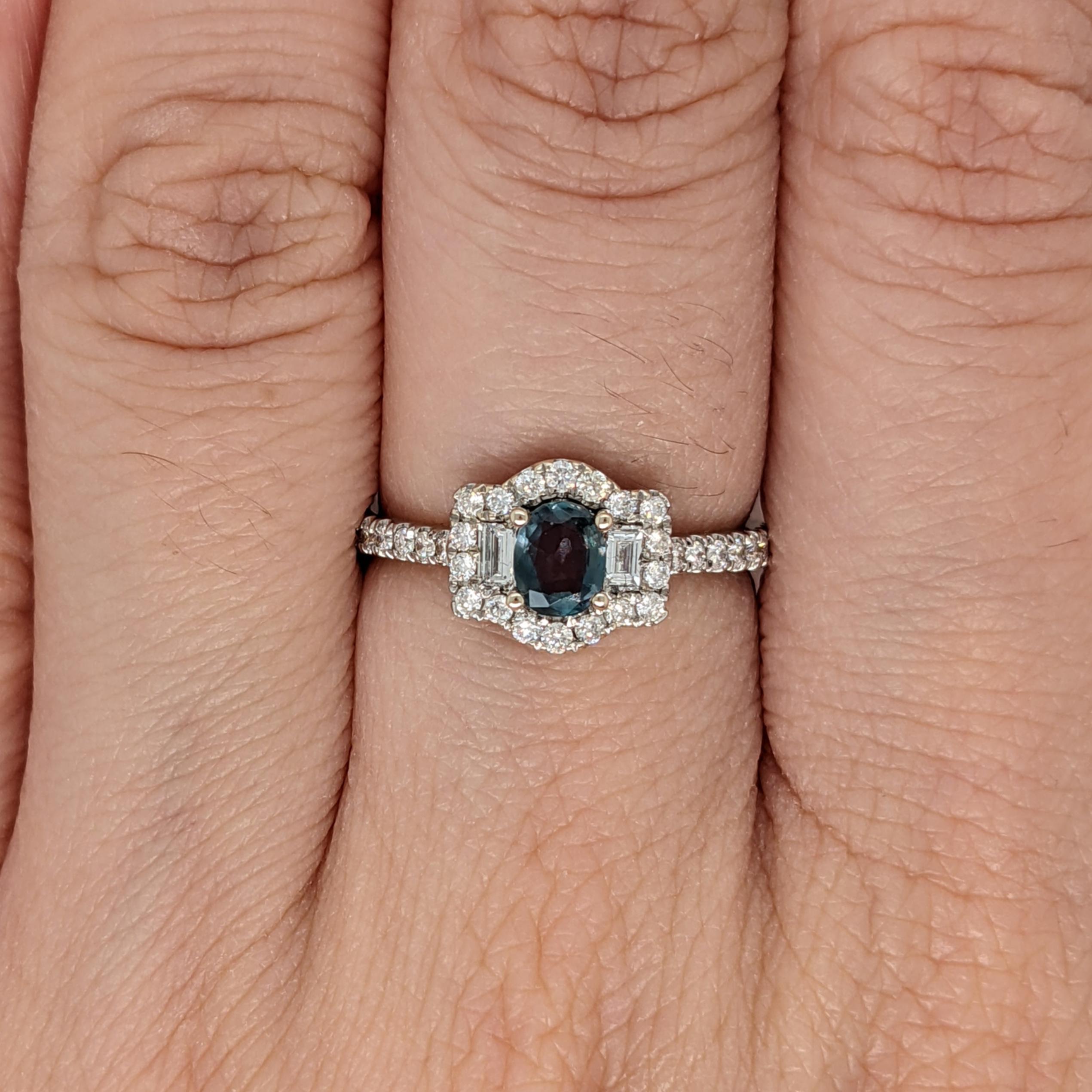 This unique ring features a natural color changing Alexandrite with natural earth-mined baguette and round diamond accents giving this ring a one-of-a-kind design. The color changing natural alexandrite appears blue green in daylight and shifts to a