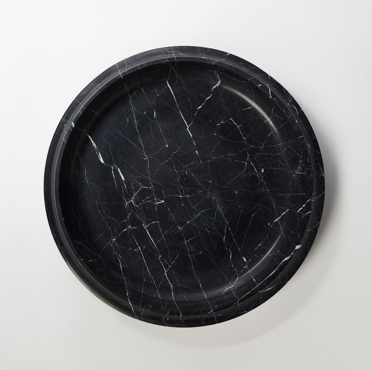 Unique nero marquina bowl 3 by Matthew Fisher
Unique piece
Dimensions: 45.7 D x 7.6 H cm
Materials: Nero marquina

Sitting softly upon an elongated curved base, the column of the object terminates at a lip detailed to catch light. Carved from