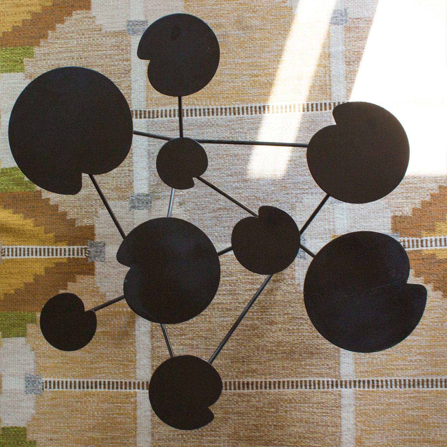Absolutely gorgeous, original and rare Scandinavian Modern coffee table, circa 1950. Nine beautifully arranged water lily leaf in different sizes, standing on three legs. Black lacquered iron and original condition. Designer unknown. Measures: