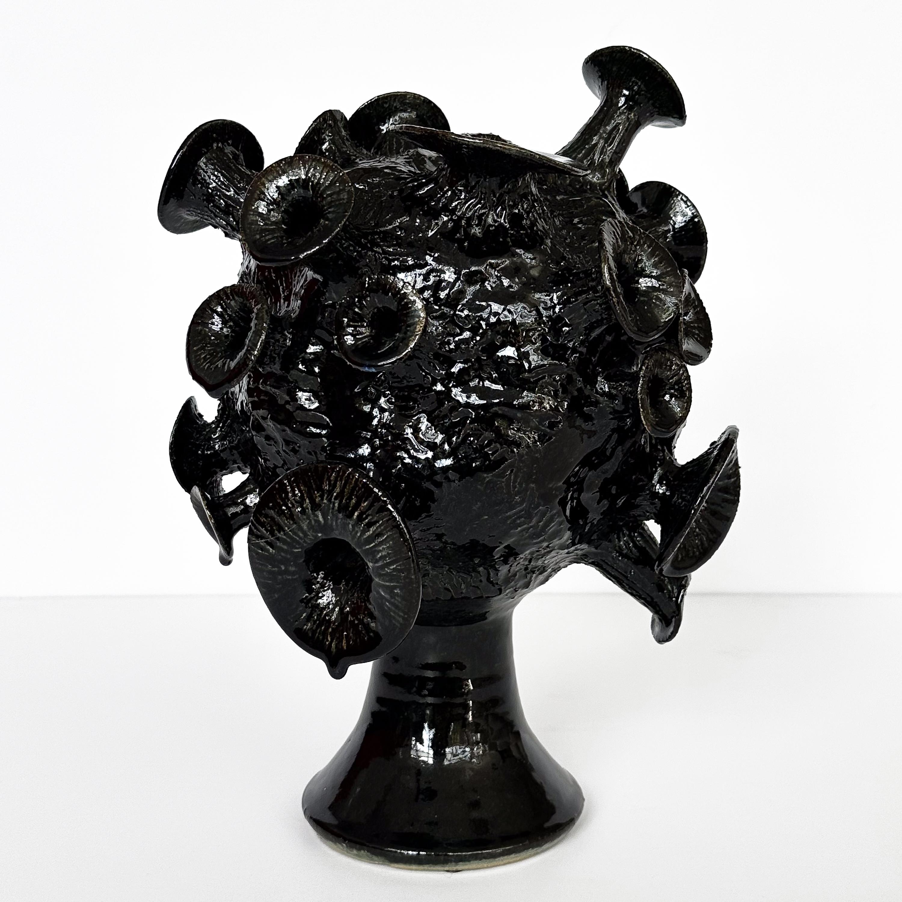 Dive deep into a realm of artistic enigma with this remarkable abstract black glazed pottery sculpture, signed 