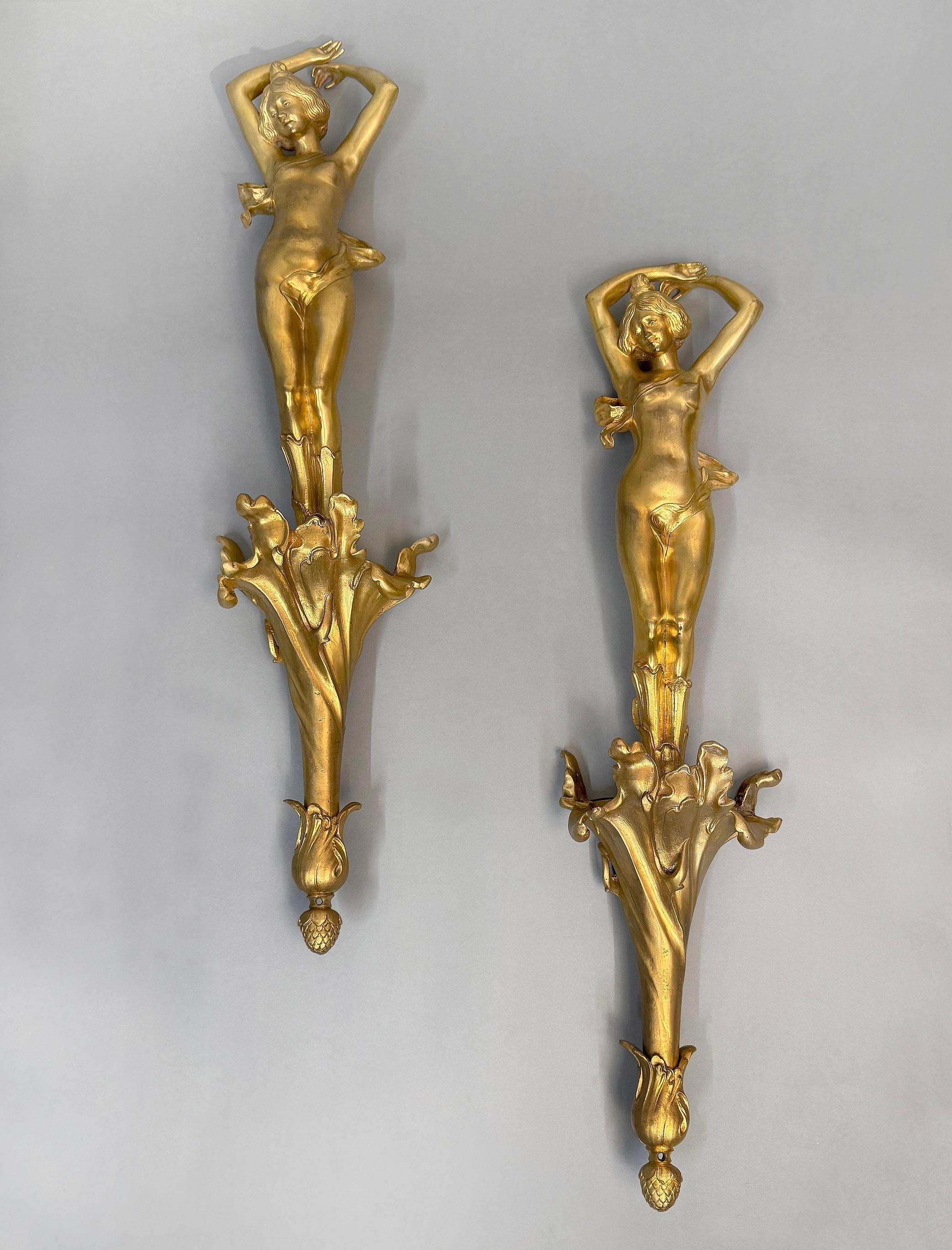 A Unique Pair of Early 20th Century Art Nouveau Gilt Bronze Hanging Wall Sculptures

Depicting a beautiful scantily clad woman, hands raised above her head, standing on a designed spiral base with an acorn finial.

Items like these are known to been