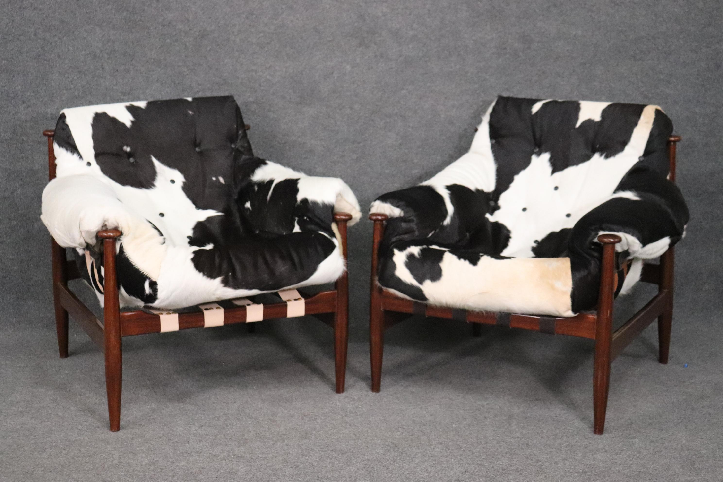 This is a beautiful pair of cowhide upholstered club chairs. They are in good condition and have nice upholstery but the webbing is different on one chair. The chairs each measure 34 tall x 36 wide x 37 deep and the seat height is 21 inches.