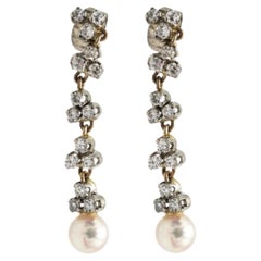 Unique pair of 14k white and yellow gold earrings with pearls and diamonds.