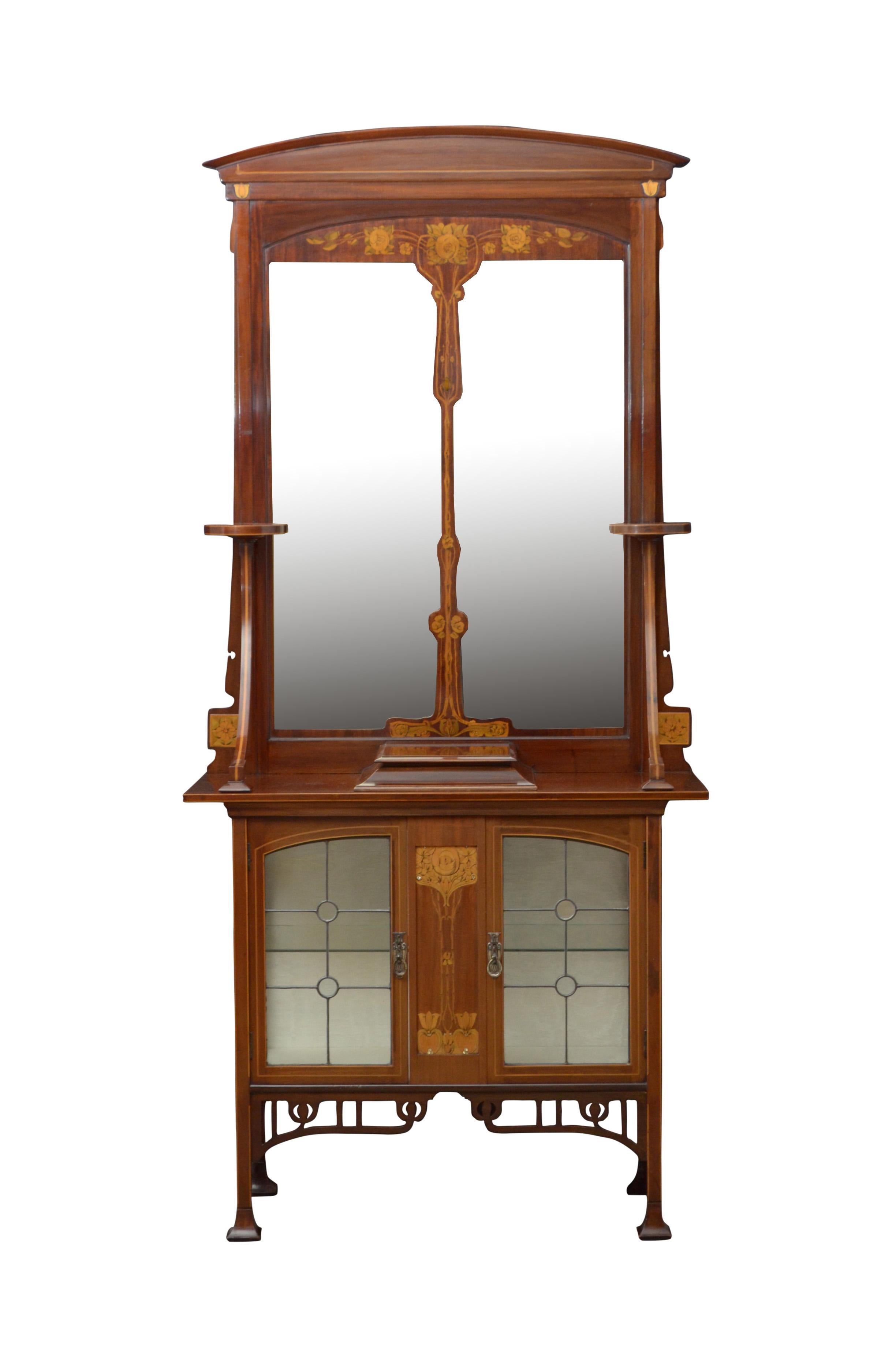 Two superb Art Nouveau mahogany and inlaid cabinets with mirrors.
Art Nouveau mahogany and marquetry hall cabinets, each having arched cresting above divided mirror flanked by a pair of circular platforms on downswept supports, the projecting base