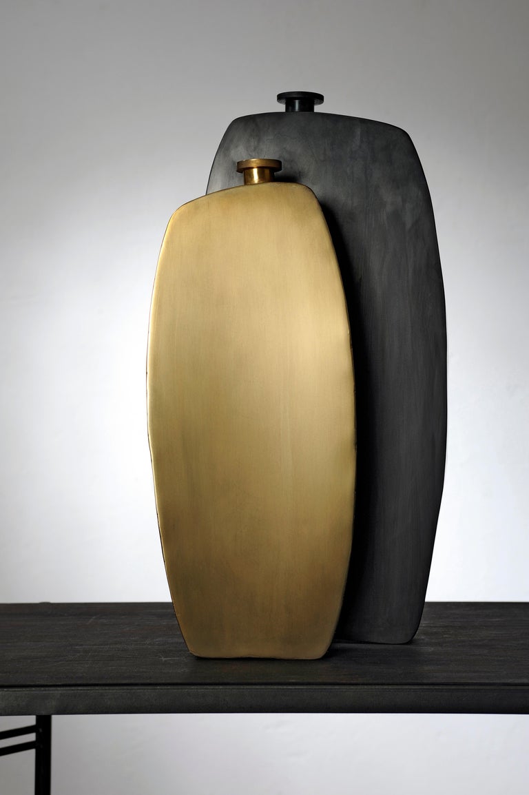 Unique pair of bottles, hand sculpted and signed by Lukasz Friedrich
Signed and numbered vases.

Measures: Large steel bottle
22 x 5 x H 46 cm
Brass bottle
16.5 x 5 x H 39.5
Finish: patinated brass, wax.