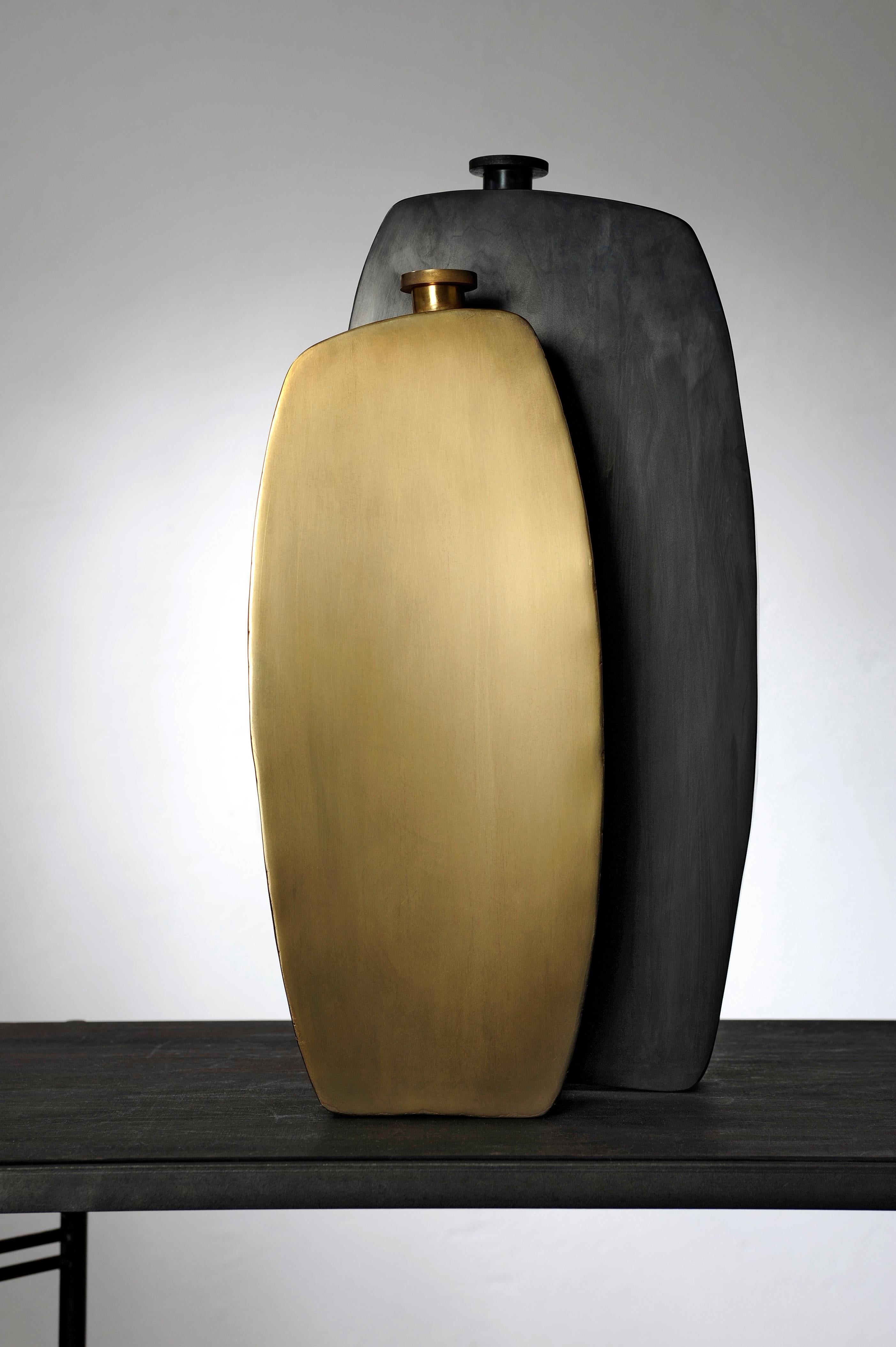 Unique pair of bottles, hand sculpted and signed by Lukasz Friedrich
Signed and numbered vases.

Measures: Large steel bottle
22 x 5 x H 46 cm
Brass bottle
16.5 x 5 x H 39.5
Finish: patinated brass, wax.