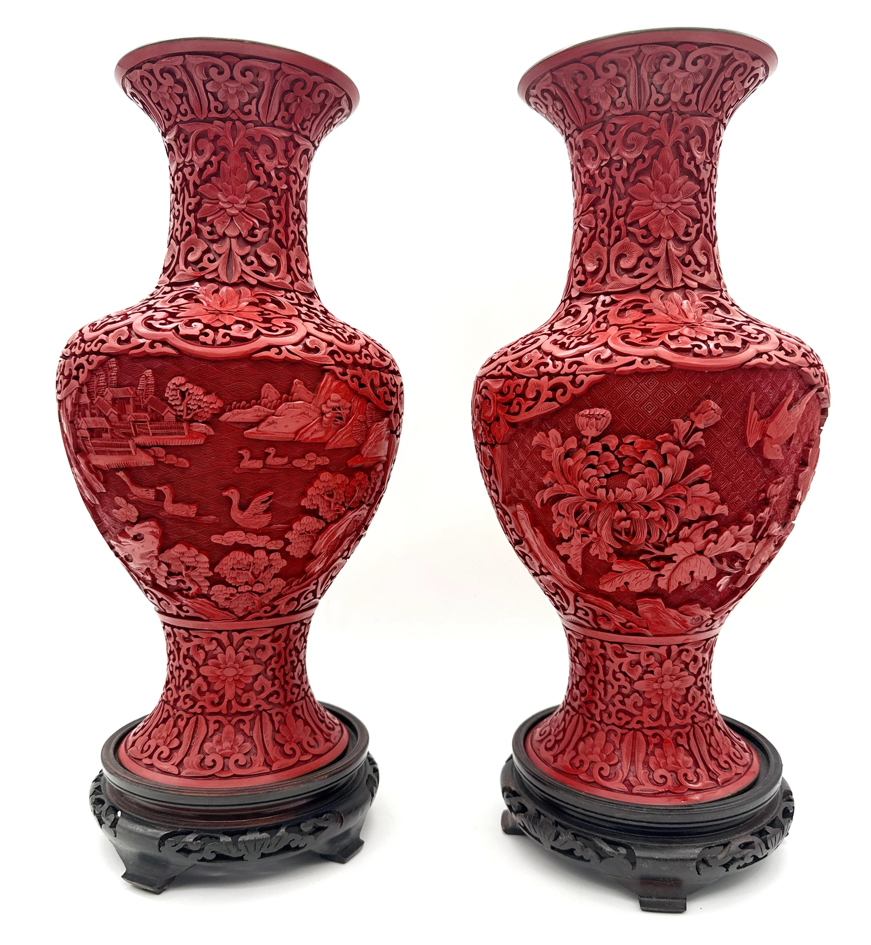 Unique Pair of Chinese Carved Cinnabar Vase, Same Shape, Different Decoration, China, Cultural Revolution Period 1966-1976
The vases are accompanied by a fine pair of carved hardwood stands. 

A unique pair of Chinese-carved cinnabar vases from the