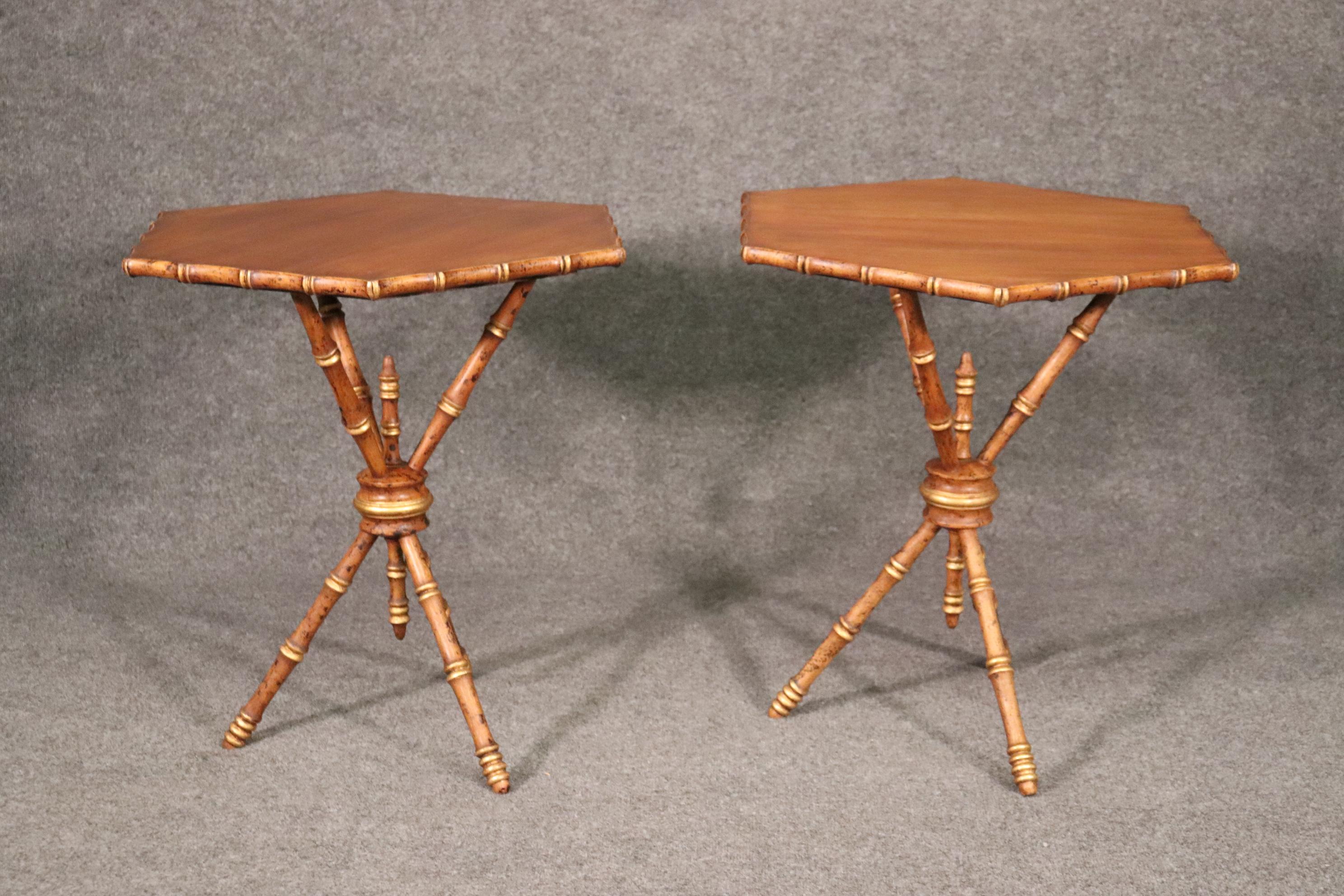 This is a fine pair of French faux bamboo end tables with gold leaf gilded details and beautiful faux distressing to make them look like real bamboo. The tables are in good used vintage condition and measure 25 tall x 21 wide x 21 deep. They date to