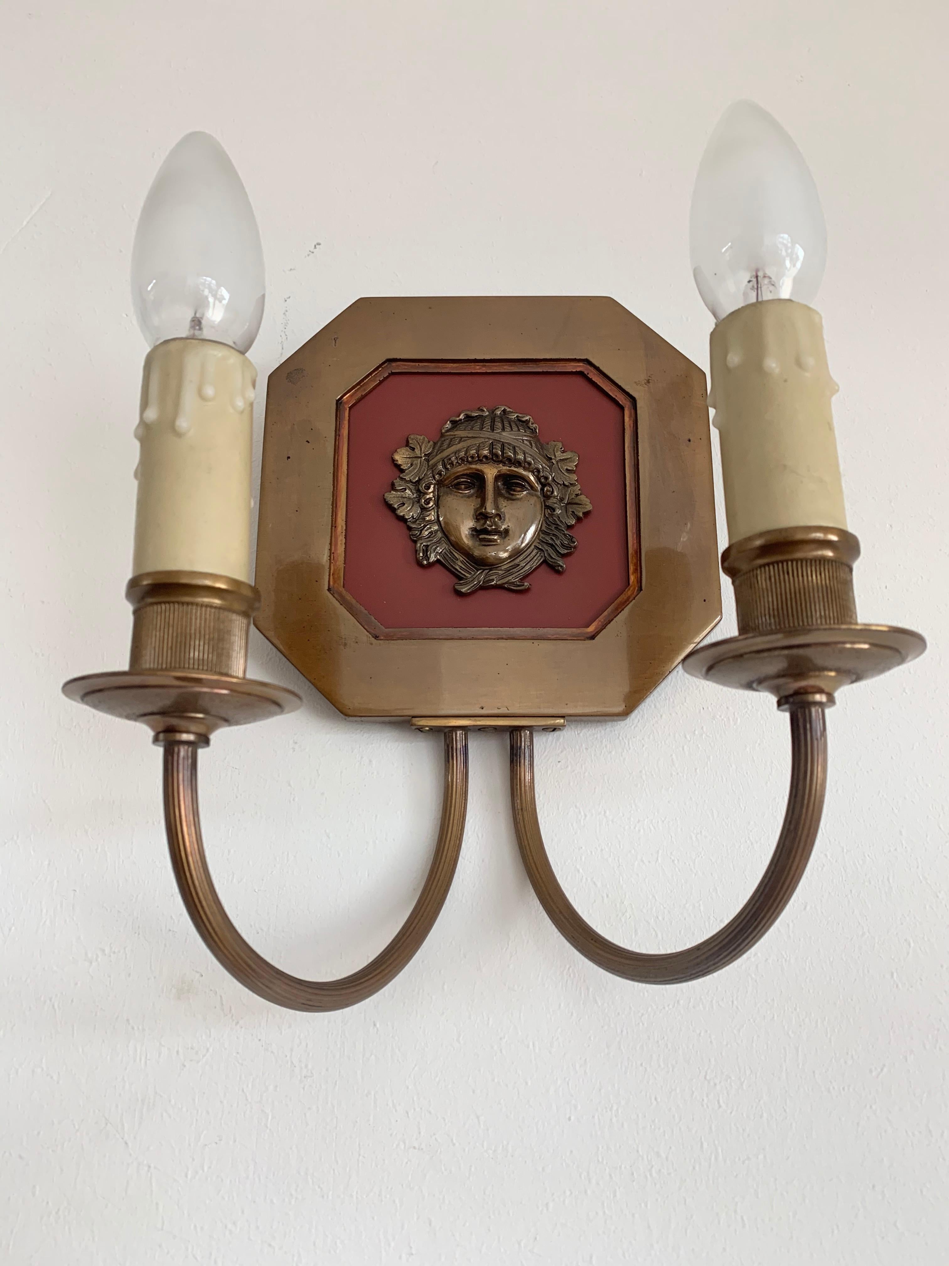 Maison Charles pair of French Empire style bronze two-light wall sconces with detailed women heads, from the 1970s. 

Marked on the back 