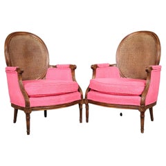 Unique Pair of French Louis XVI Style Walnut Cane Back Bergere Chairs Circa 1960