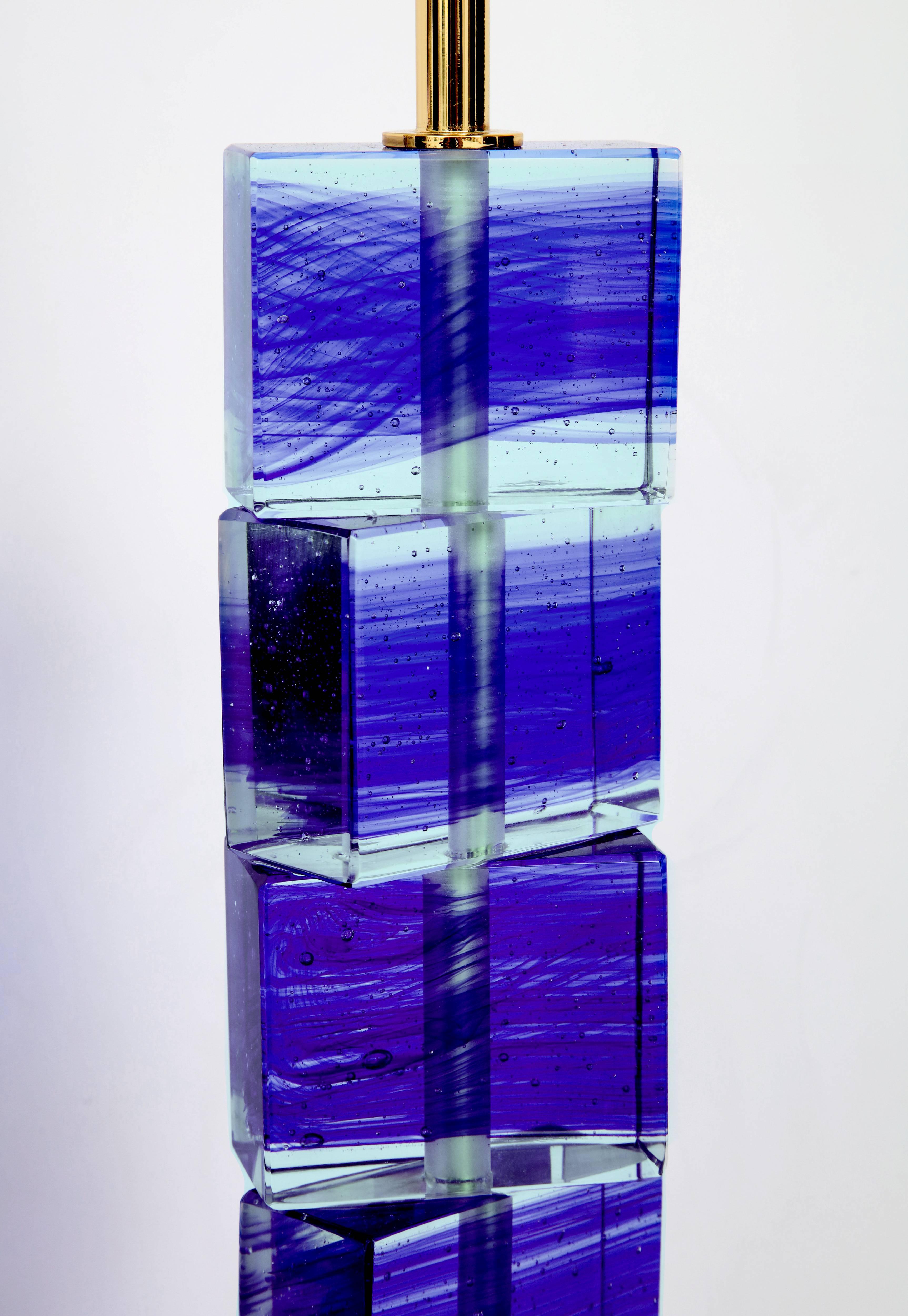 Pair of Italian cobalt blue and clear Murano glass block lamps with solid glass base. The solid blocks on the base swivel to create numerous configurations. The color of the glass can become deeper or lighter depending on the surroundings. These