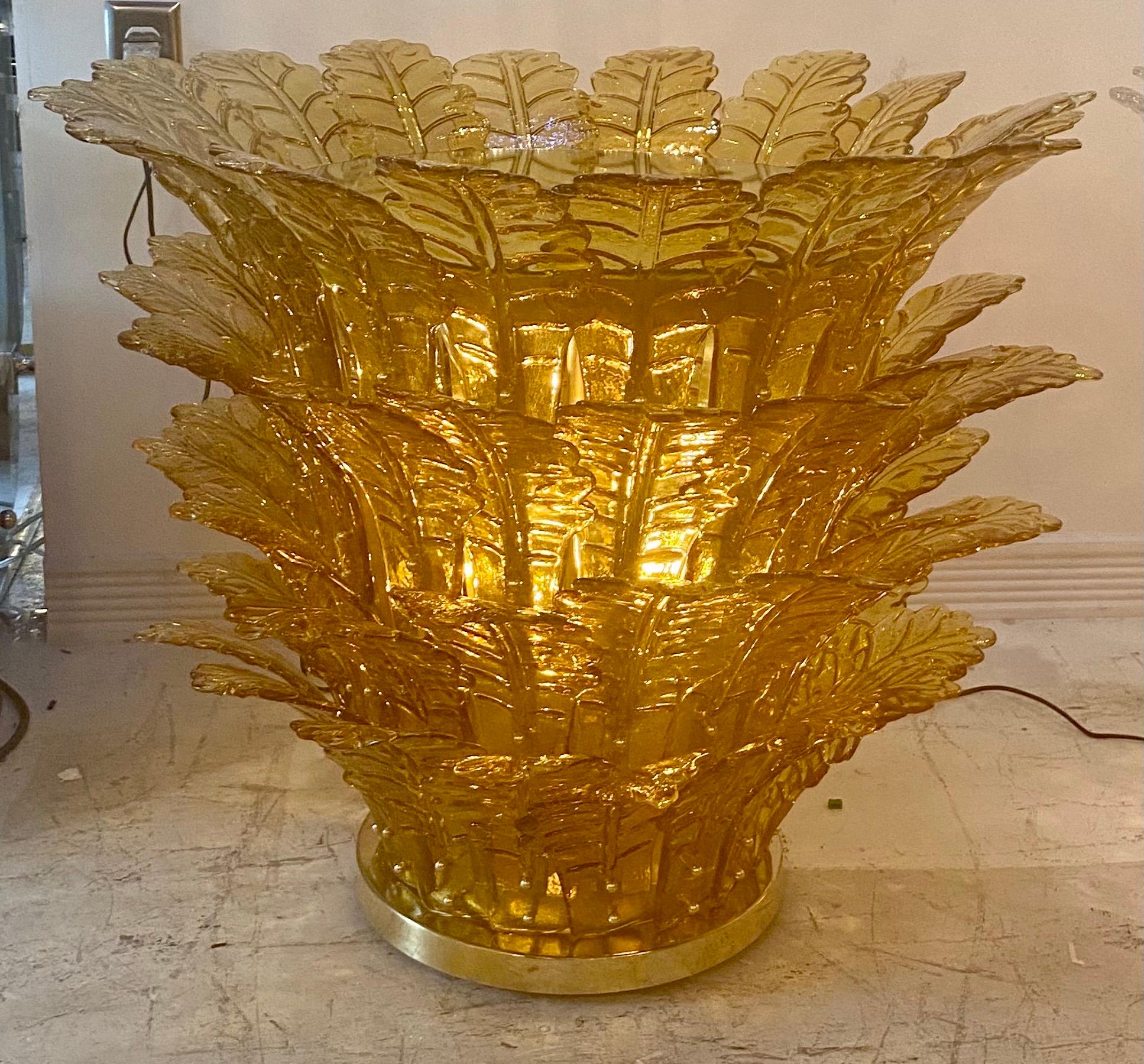 Mid-Century Modern Italian illuminant table with lit glass, dressed with amber Murano glass leaves mounted on brass base. Sublime and unique tables in very good condition.