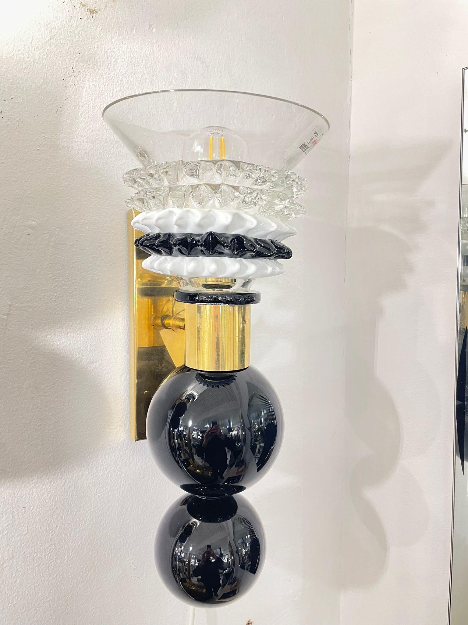 A rare hand blown Murano glass wall lights/sconces by the renowned glass manufacturer Barovier & Toso, Italy, 1960s The black elements with white and black glass shades give the wall lights a very elegant and unique design. 
The wall lights are in