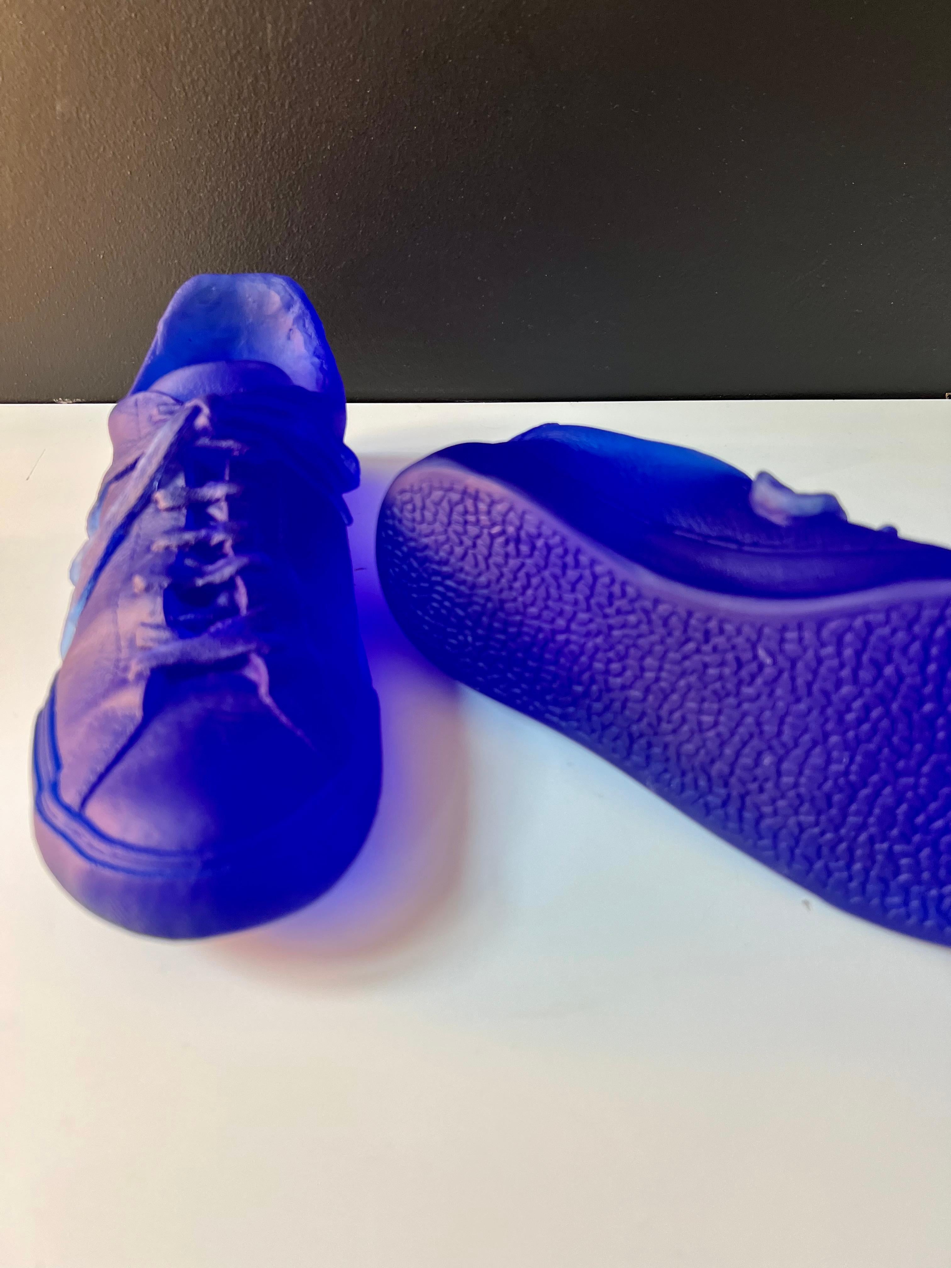 A pair of unique cast glass sneakers of the artist's own shoes in cobalt blue color. The size is true to original Vans sneakers that have been used by the artist herself. The resulting work has all the intricate details of the original pair of