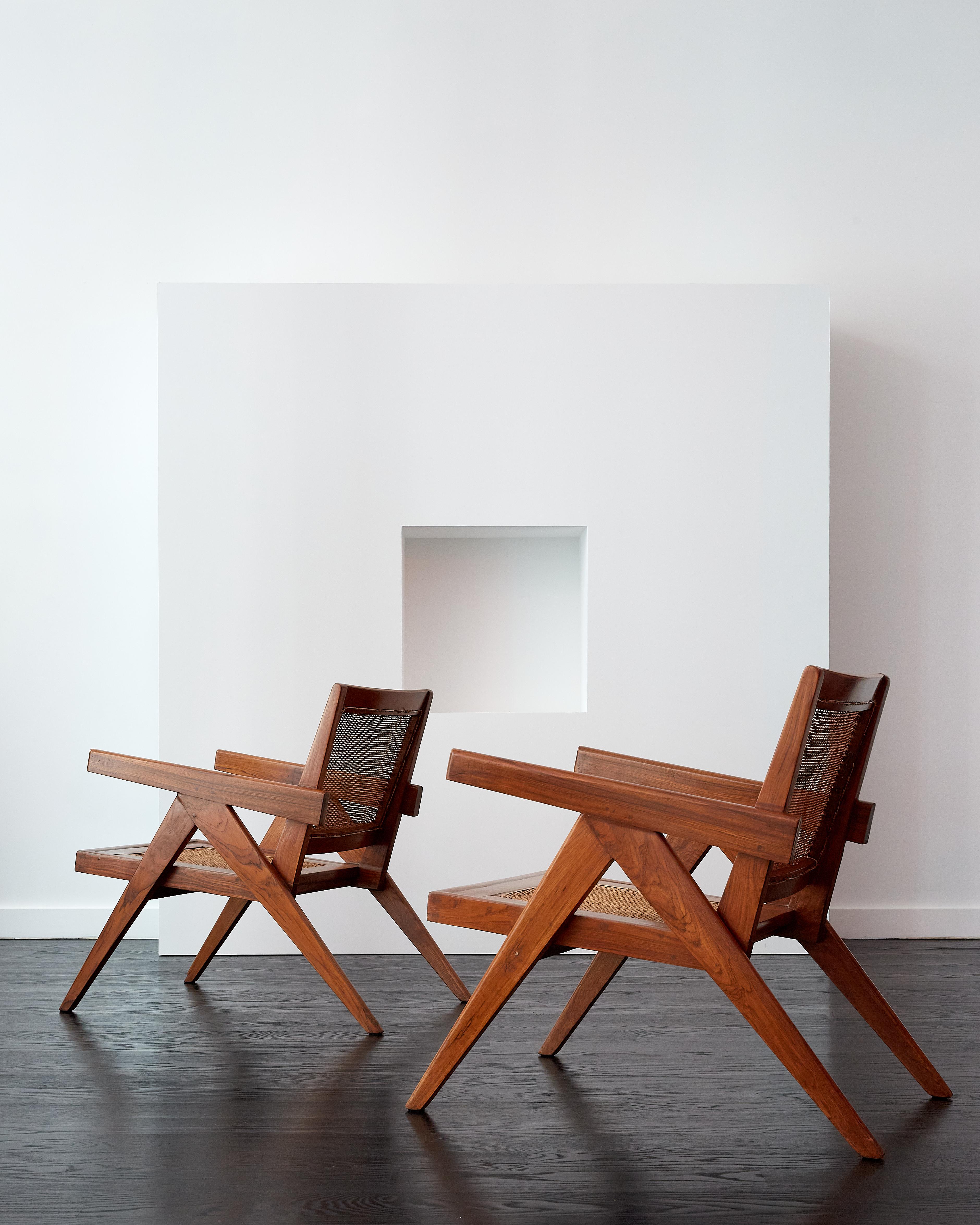 A unique pair of Pierre Jeanneret solid teak lounge chairs with an extreme splay in the inverted ‘V’ type assembly legs.

Chandigarh c. 1960

Beautiful grain in the teak frame and legs.

Hand caned and gently conserved.

Provenance: