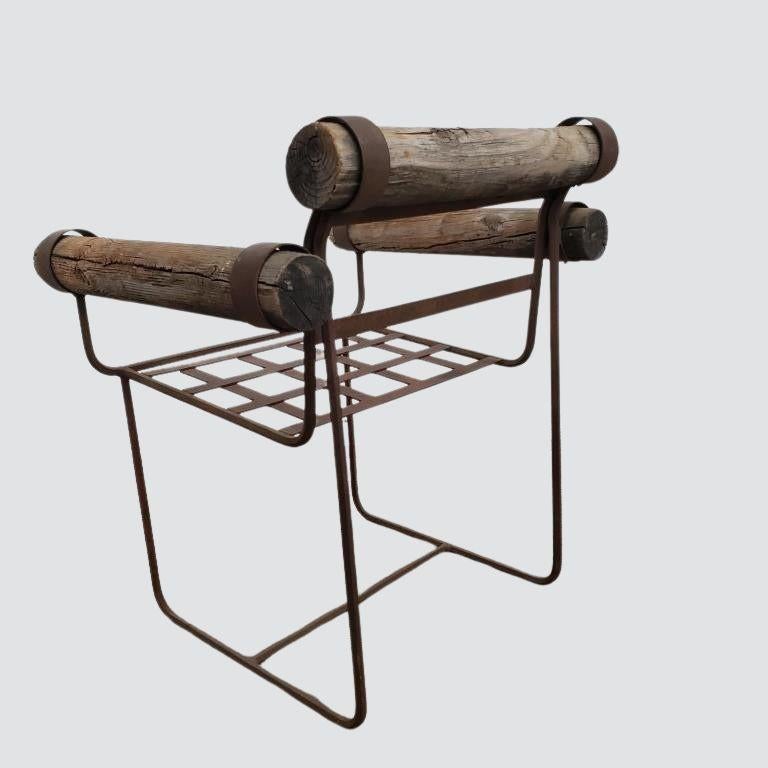 Elevate your outdoor space with this stunning pair of rustic vintage garden chairs, masterfully blending raw industrial charm with organic natural elements. These unique chairs feature a sturdy, hand-welded metal frame with a rich patina finish,
