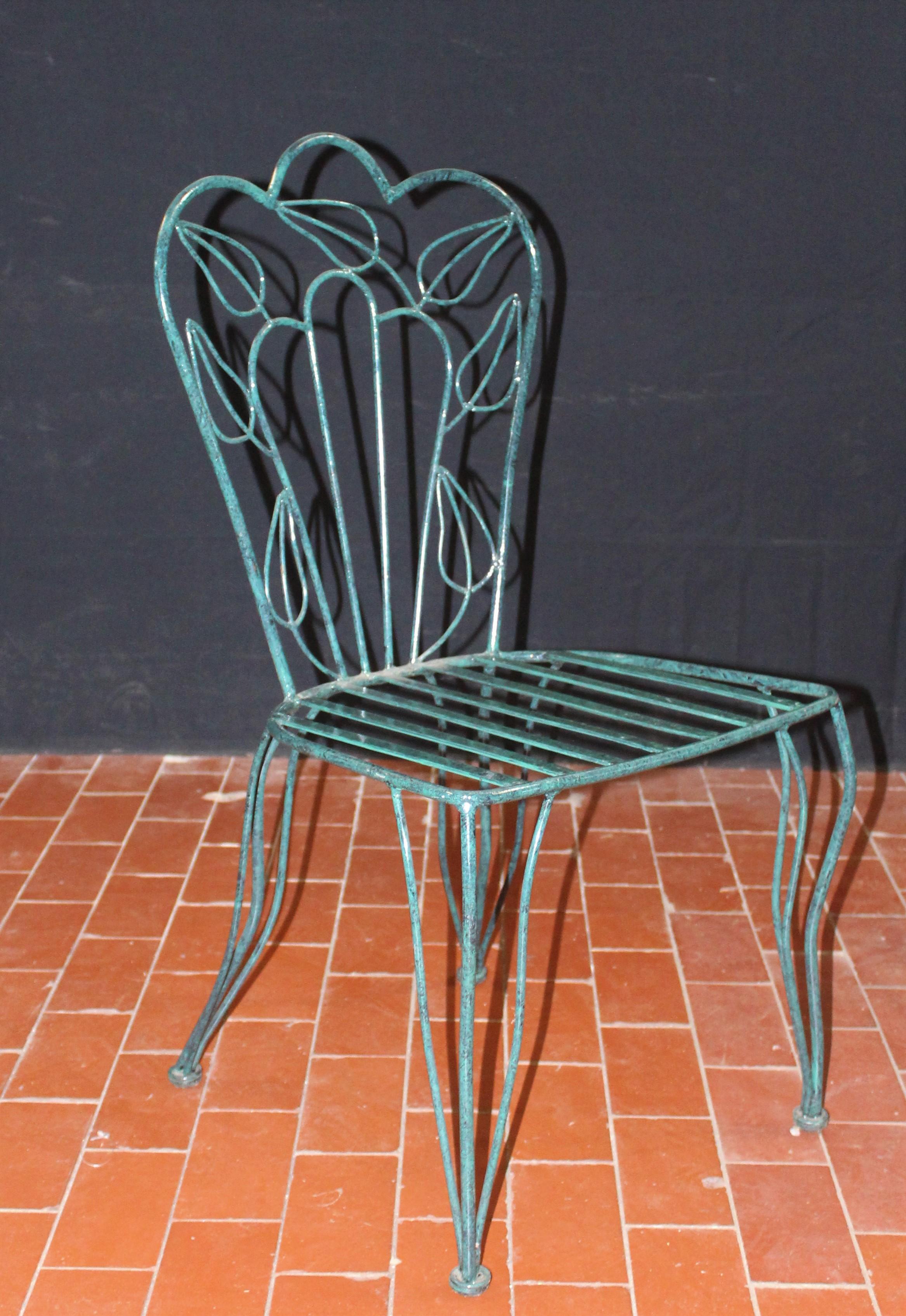 Unique pair of very stylish mottled green powder coated patio chairs.