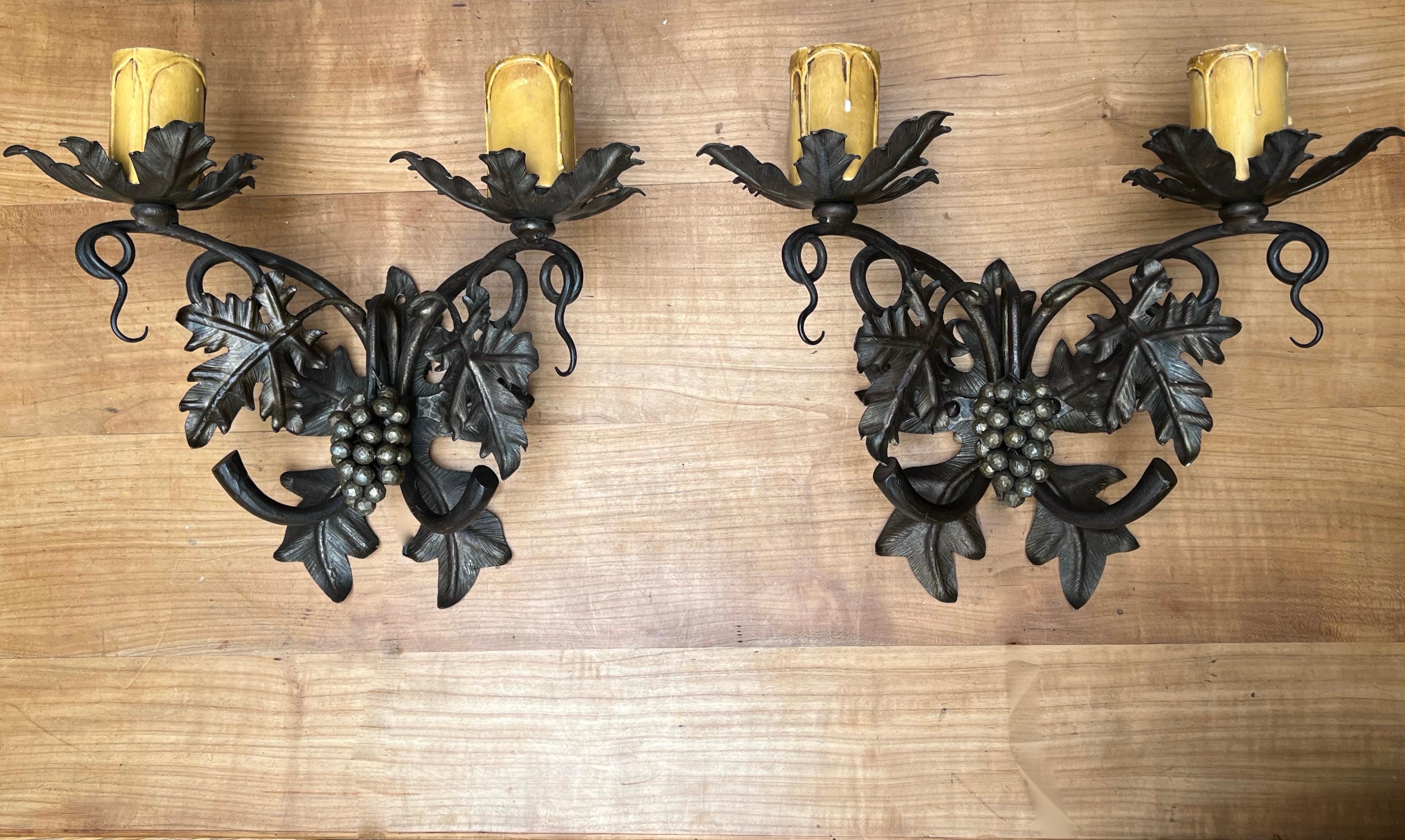 Stylish and highly decorative pair of Arts & Crafts era, work of lighting art sconces.

If you are looking for a pair of elegant and excellent condition, two-light wall sconces to grace a special space then these handcrafted fixtures could be