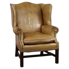 Unique patinated leather wingback armchair