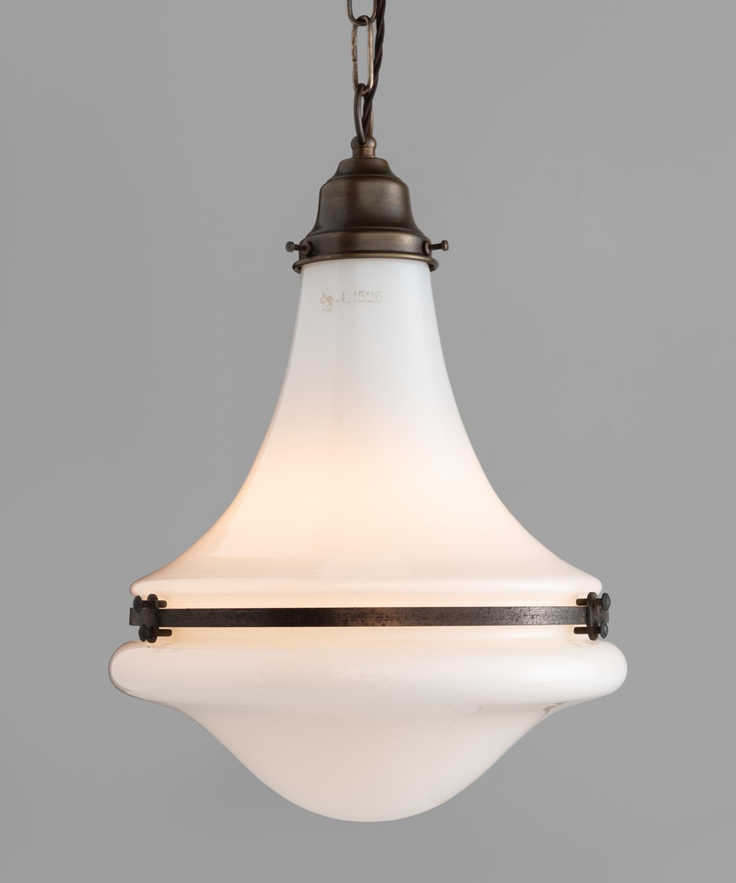 Unique pendant by Siemens, circa 1930.

Opaline shades with brass hardware and beautiful patina. Drop is adjustable.

Measures: 9.5