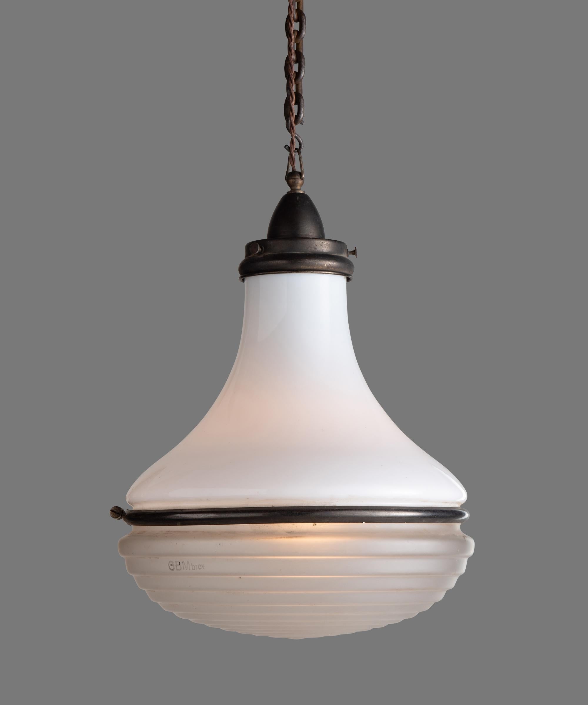 Unique pendant by Siemens, circa 1930.

White glass upper with ribbed, etched glass lower and patinated steel clasp.

Measures: 12” diameter x 19” height (to top of fitter).