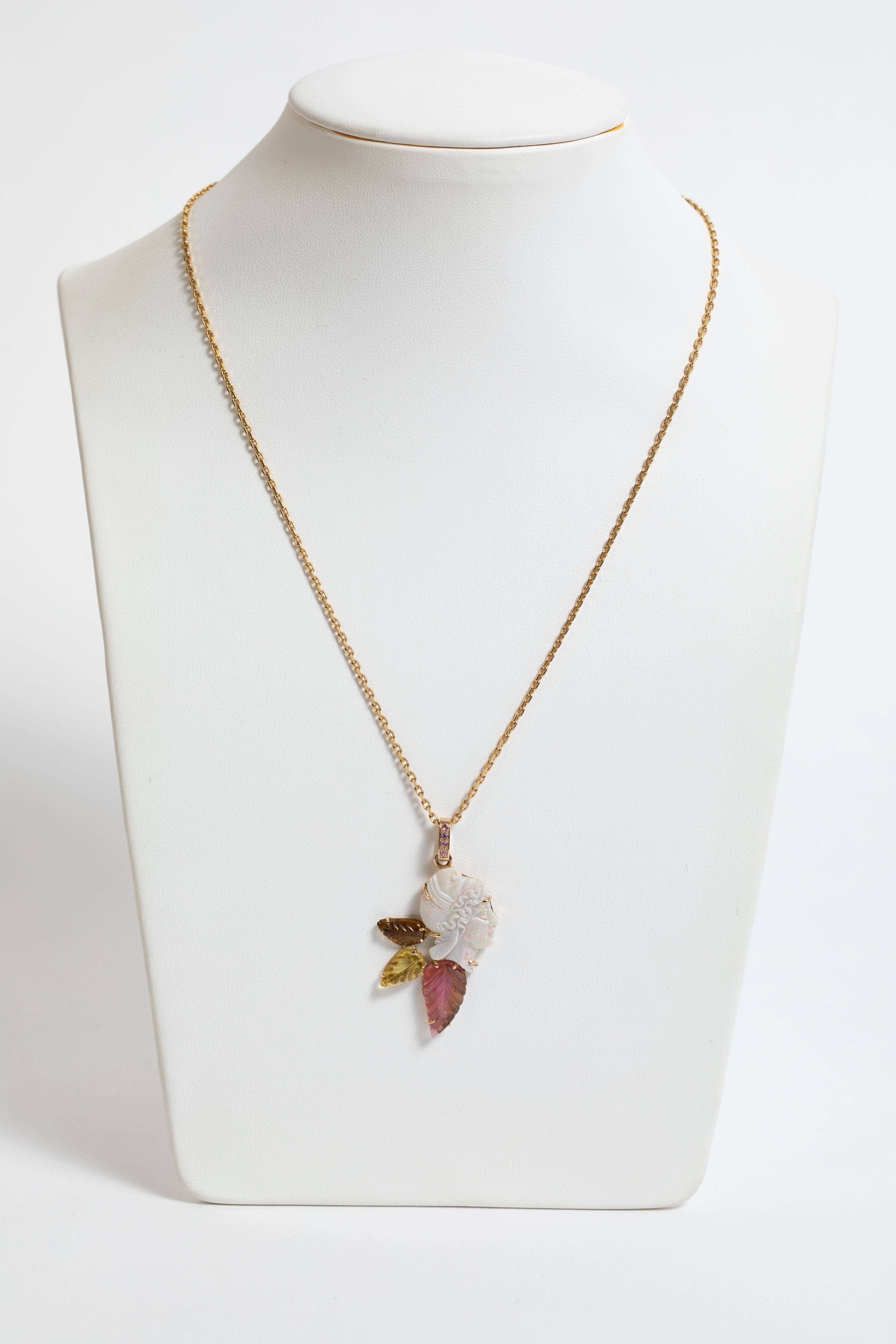 Created around the opal head, this unique necklace is georgous and luminous.
Opale head weight : 5,16 carats
3 engraved tourmalines leaf weight : 2,30 carats
Rubis on the belier : 0,05 carat
18K Yellow gold chain weight : 3,43 g 
Opale pendant :