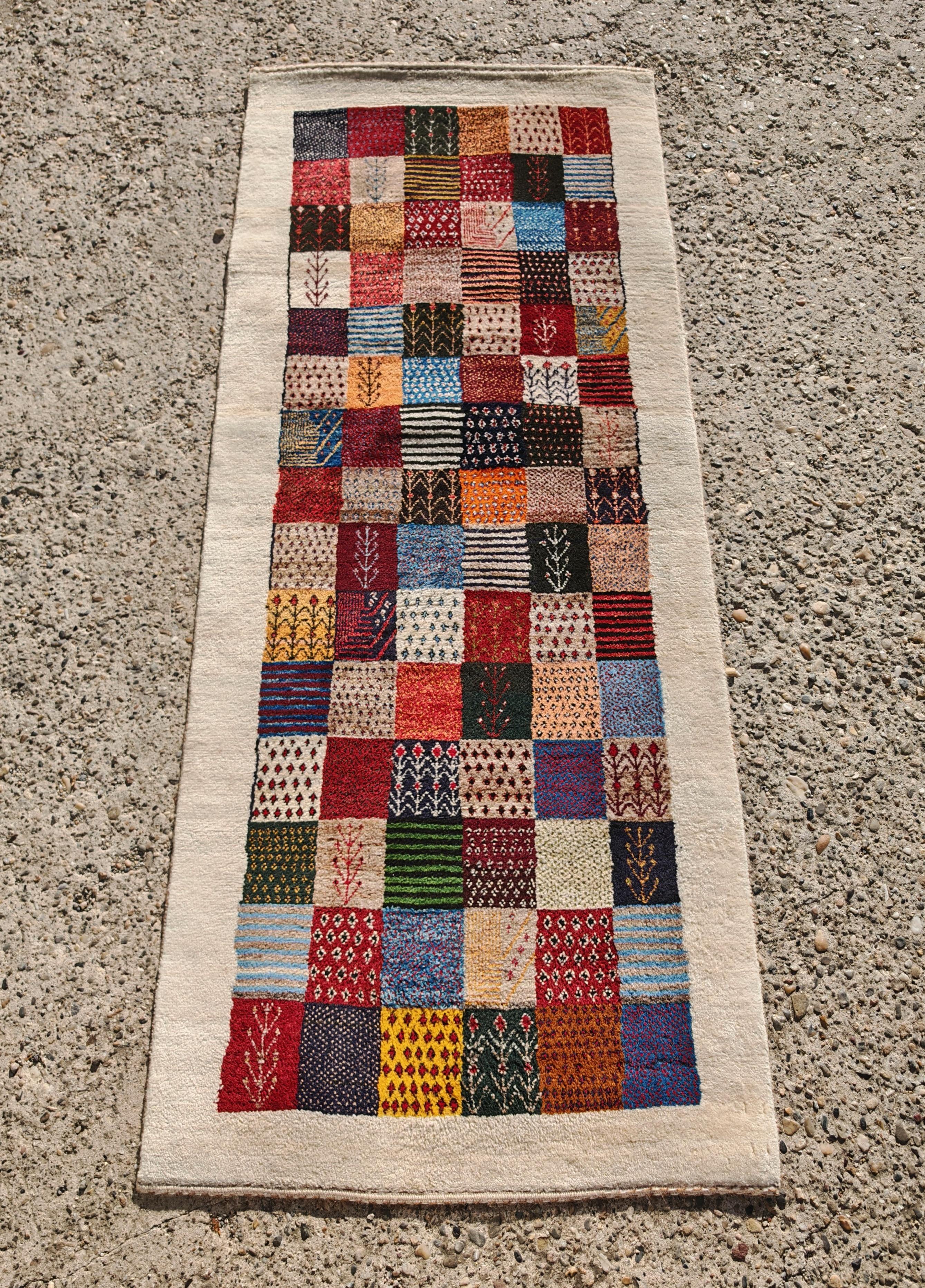In this listing you will find a unique Persian Gabbeh runner, featuring geometric and floral pattern typical for the region. The runner is done in finest virgin wool with high density weaving, making it soft and very gentle to the touch.