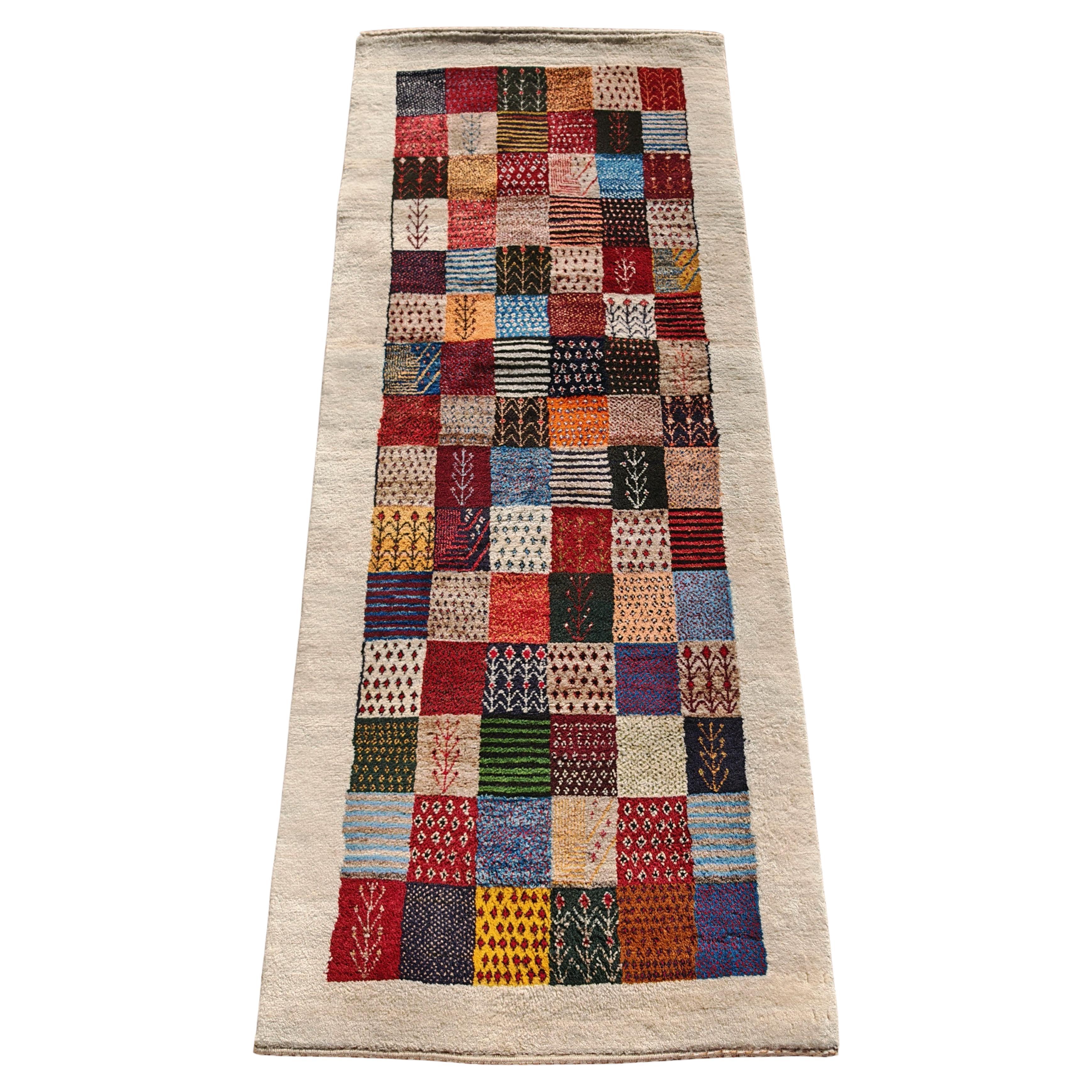 Unique Persian Gabbeh Runner with geometric and floral pattern, Iran 1990s For Sale