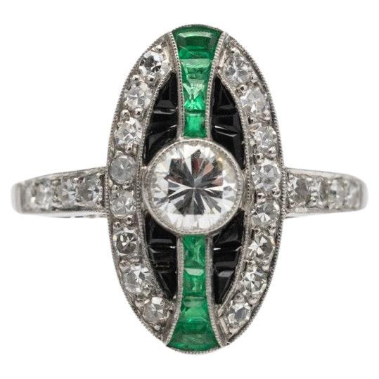 Unique platinum ring with diamonds, emeralds and onyxes in Art Deco style.