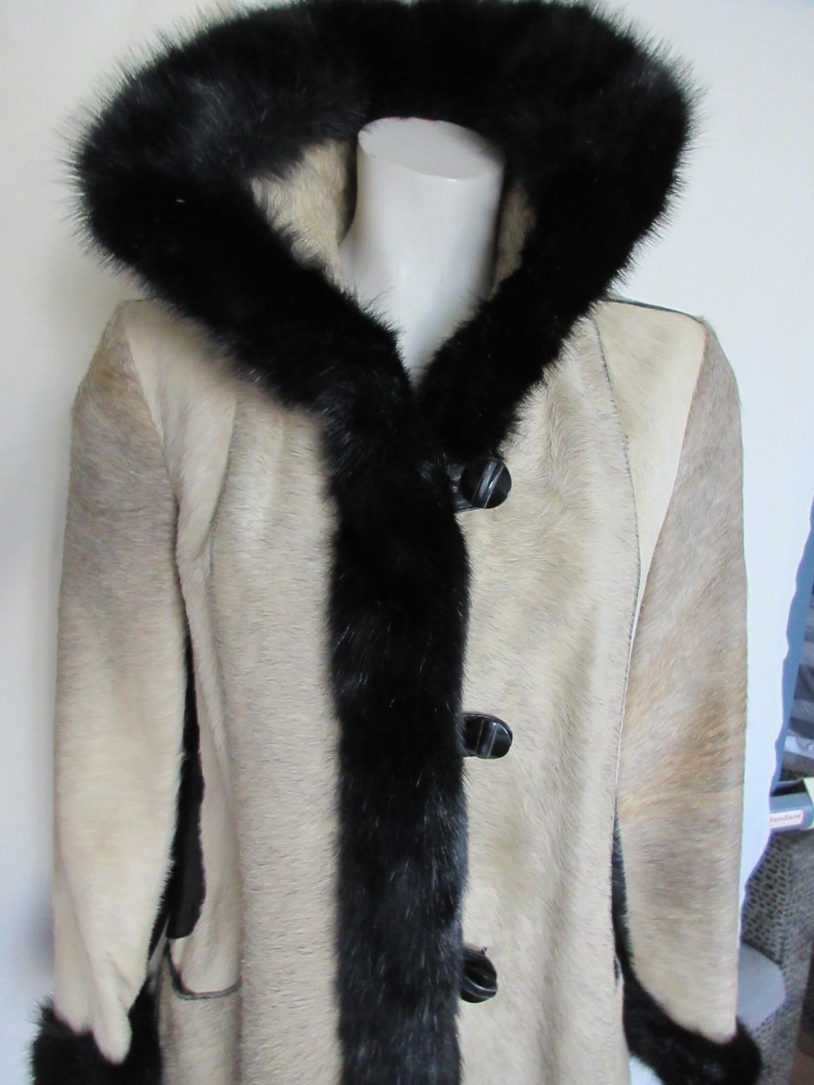 Amazing vintage hand made coat from pony skin trimmed with black mink fur at collar and cuffs 

We offer more luxurious fur items, view our storefront.

Details:
With 2 leather pockets, 5 buttons, fully lined, black mink fur trimmed.
Preloved