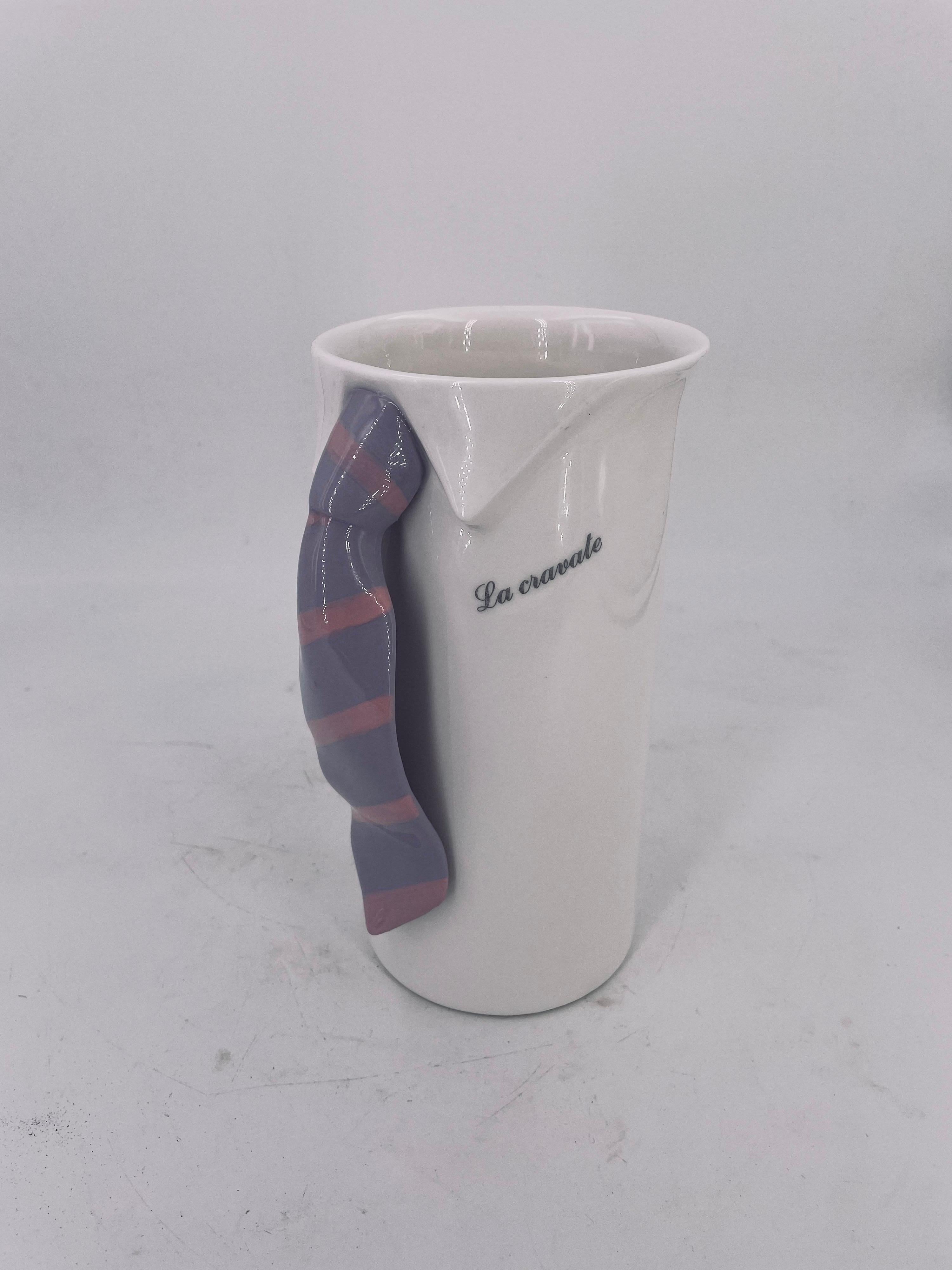Really cool and unique white porcelain pitcher circa 1980's, Made in Japan great Memphis era piece excellent condition with a tie handle, and a legend in Italian Le Cravate, The tie.